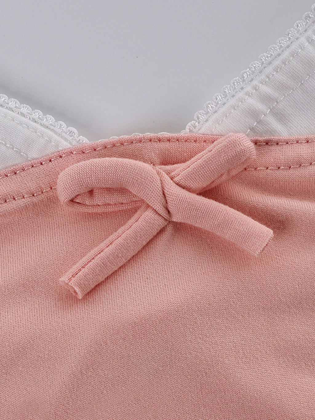 Close up of the pink Lace Trim Cami & Pants Lounge Set with a bow detail