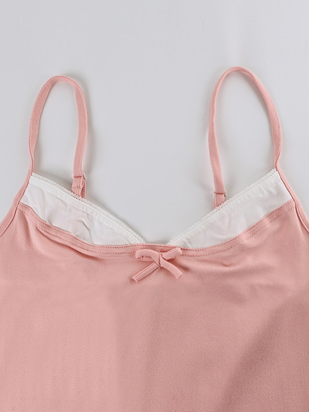 Close up of the top of the Lace Trim Cami & Pants Lounge Set, showing the pink fabric and white lace trim