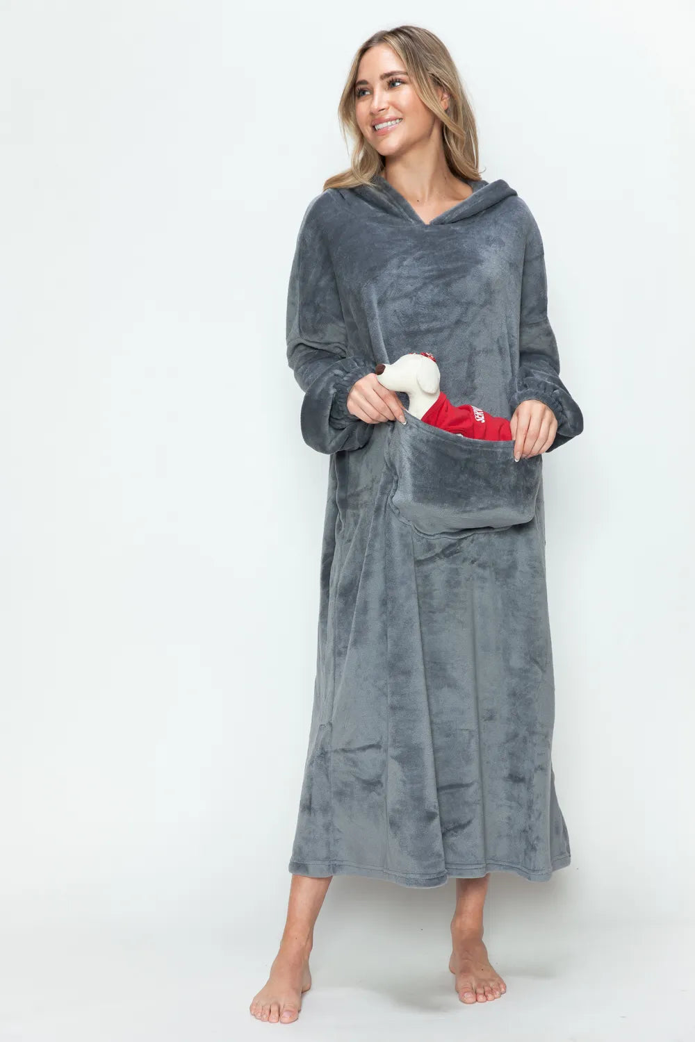 Woman in Double Take Full Size Pocketed Hooded Midi Lounge Dress, holding a small dog in the front pocket