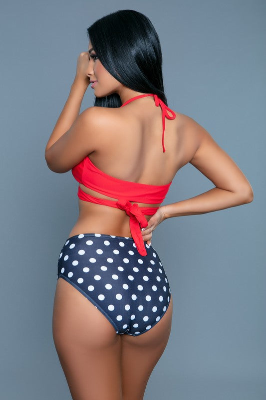 Francesca Swimsuit, red halter top and navy blue high-waisted bottoms with white polka dots