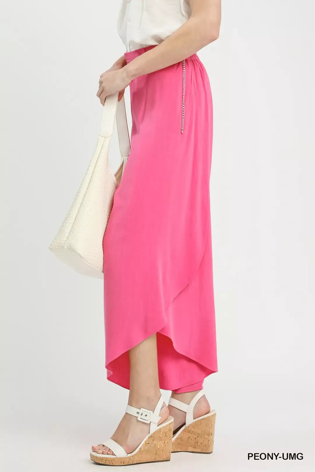 Petal Glow Asymmetrical Hem Wide-Leg Pants in bright pink, with a white top, white bag, and white wedge sandals