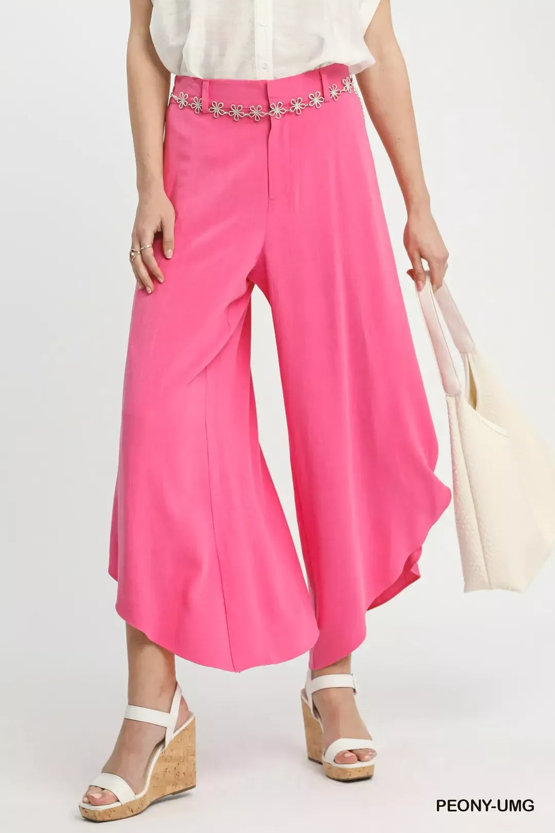 Petal Glow Asymmetrical Hem Wide-Leg Pants in bright pink, paired with white wedge sandals and a white bag