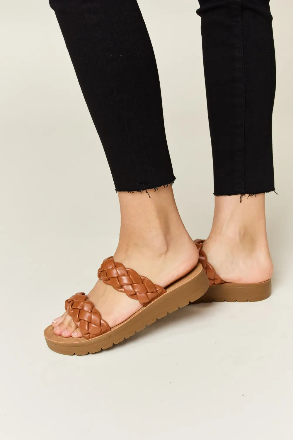 Woven Dual Band Platform Sandals in brown on a person's feet, wearing black pants