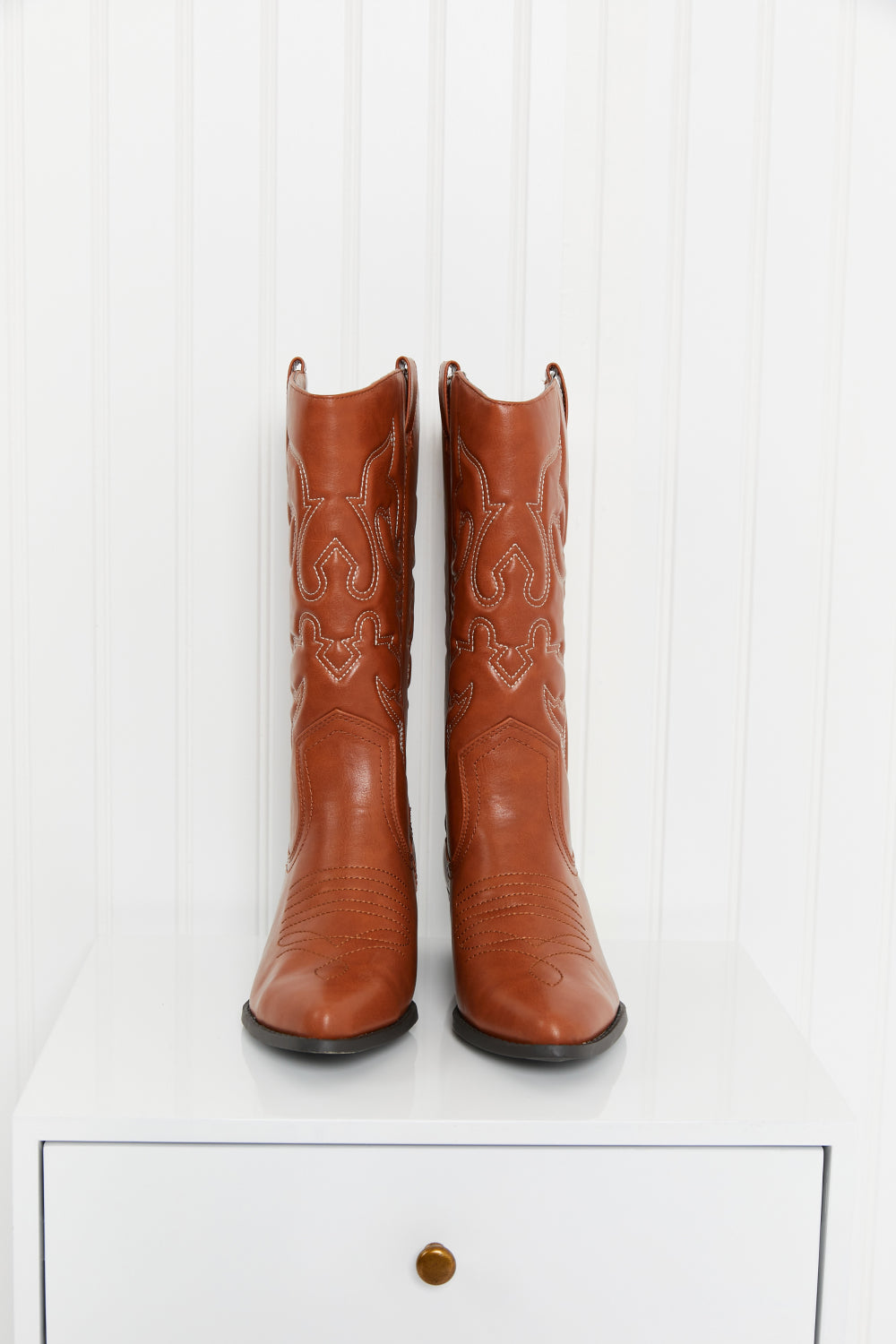Embroidered Mid-Calf Cowboy Boots in brown with white stitching on a white surface