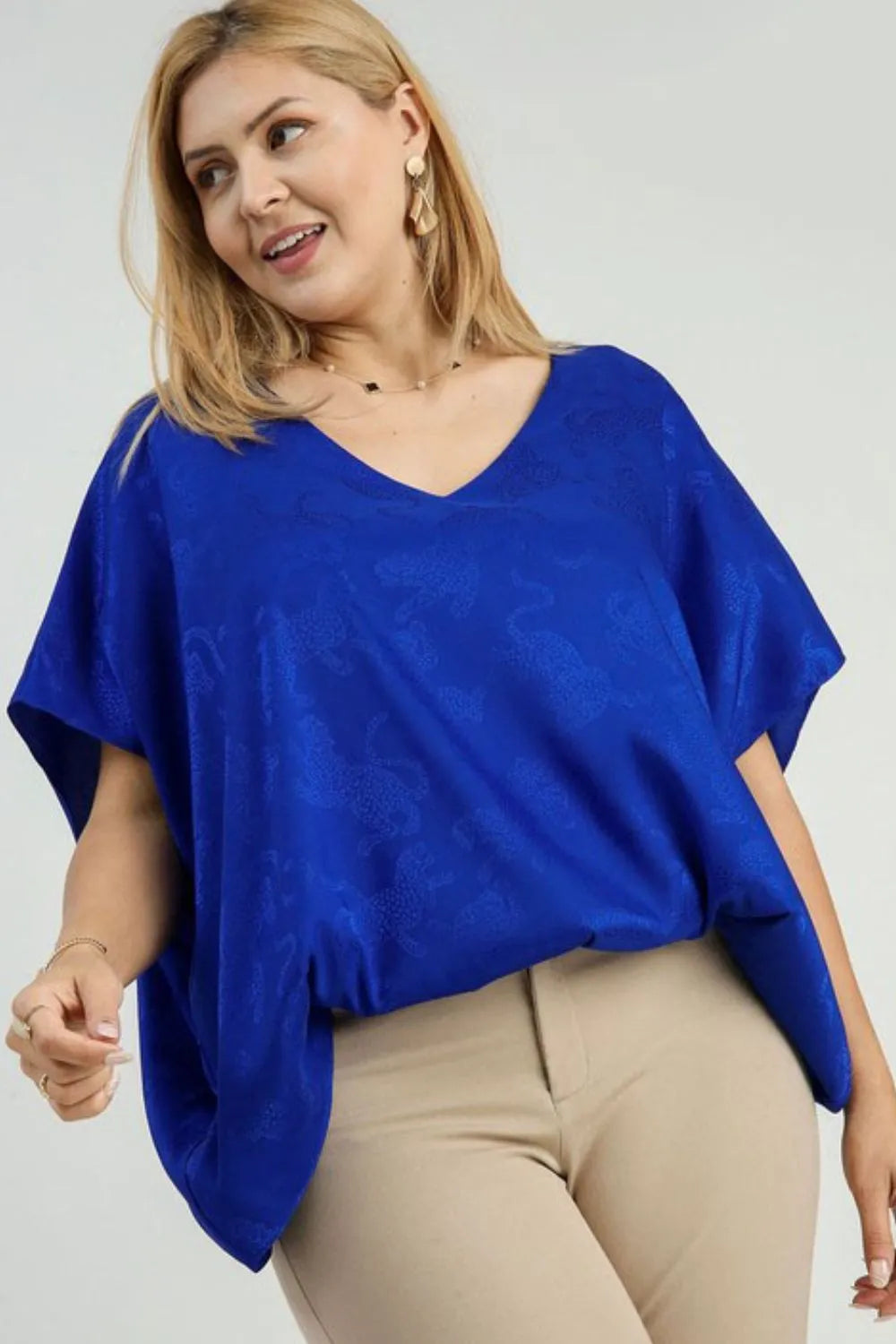 Umgee Satin Animal Print Jacquard Bubble Hem Top Plus Size in royal blue with tan pants