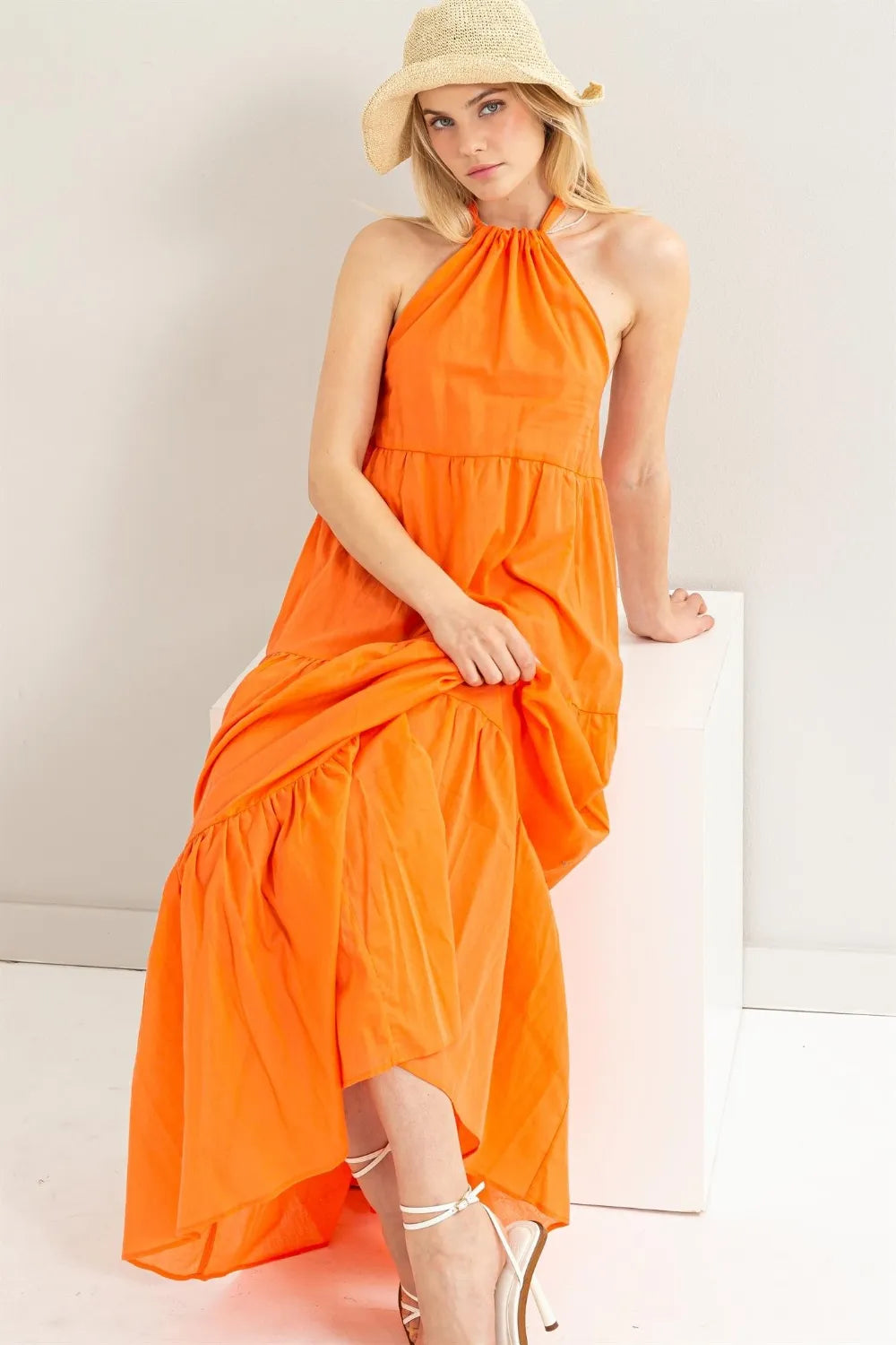 HYFVE Halter Neck Cover Up Maxi Dress in orange with a straw hat and white heels