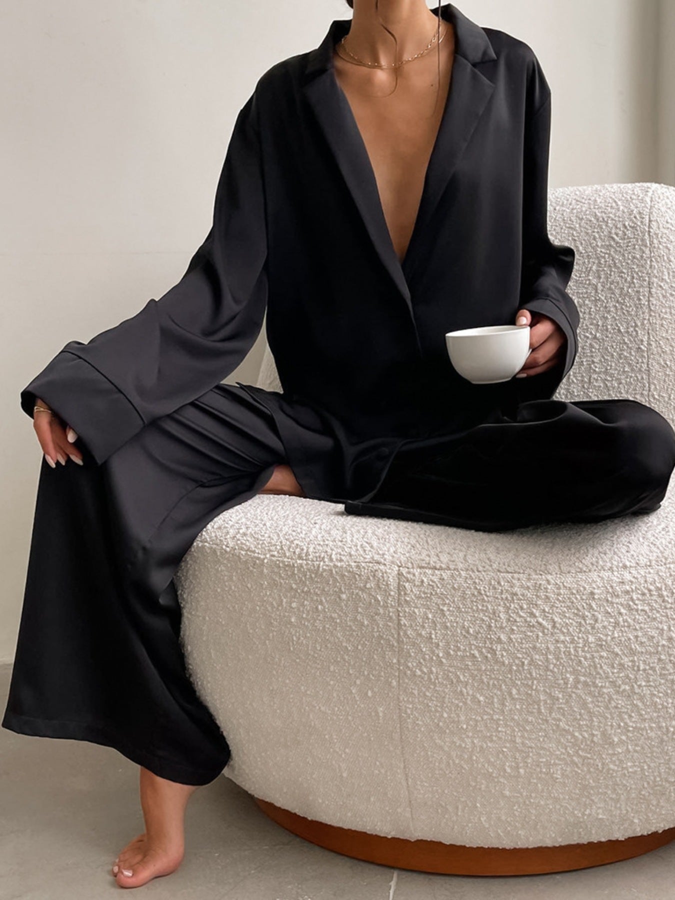 Long Sleeve Top and Wide Leg Pants Lounge Set in black, worn by a person seated on a chair