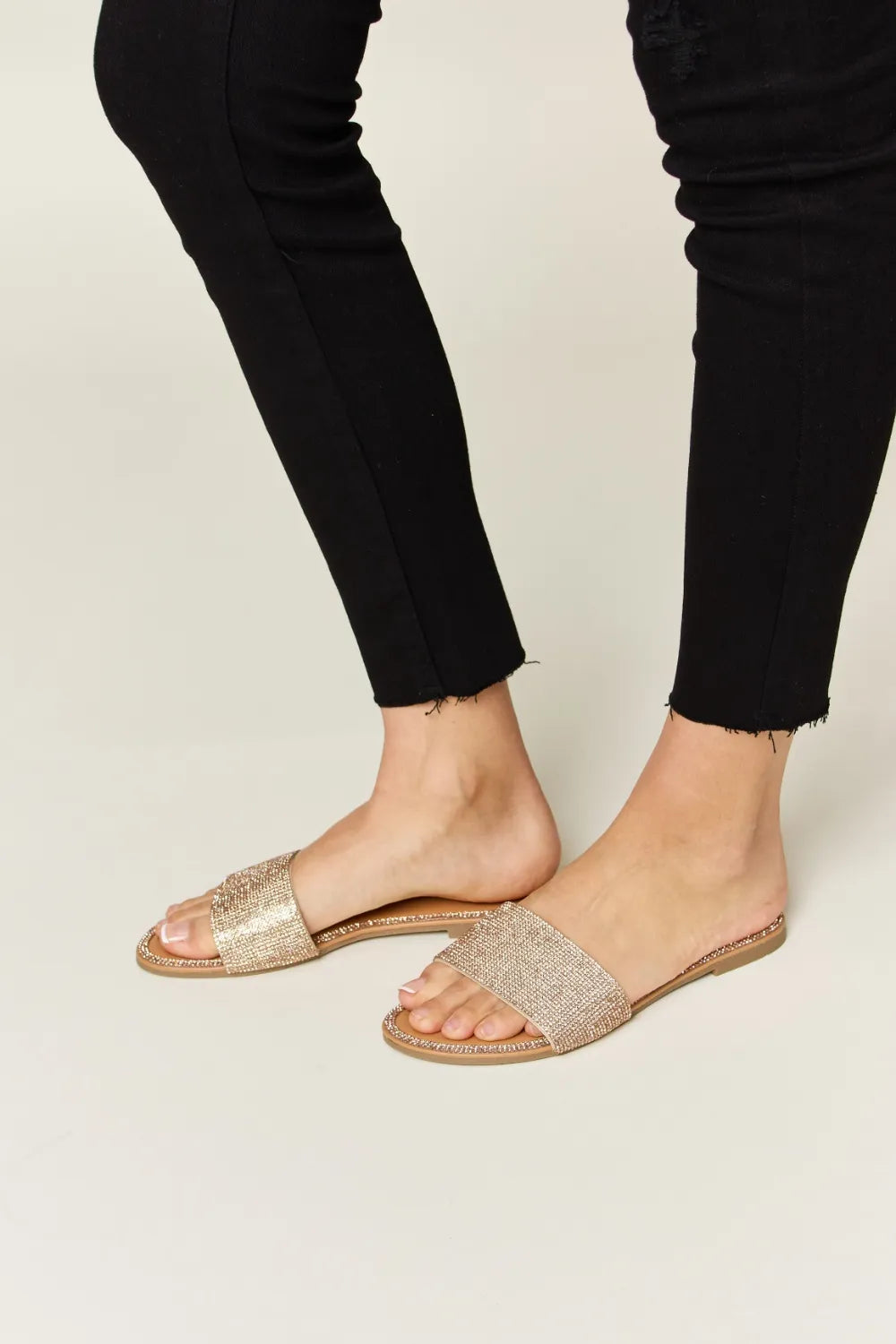 Rhinestone Open Toe Flat Sandals on feet with black pants