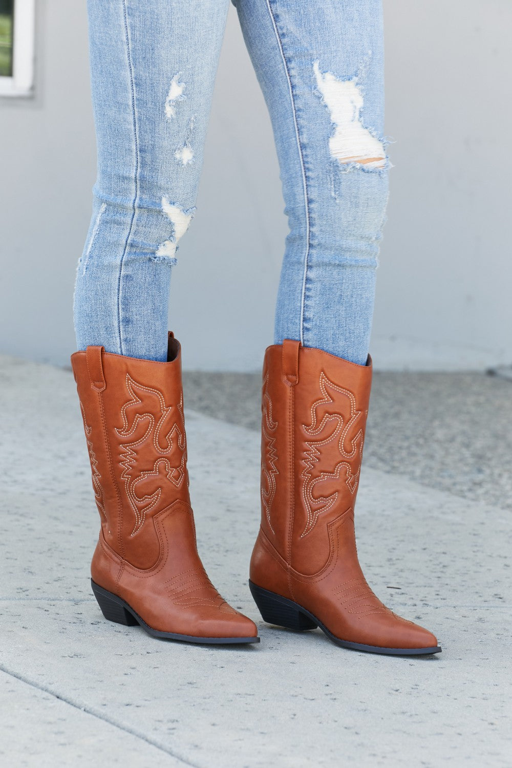 Embroidered Mid-Calf Cowboy Boots in brown with white stitching, worn with light blue distressed jeans