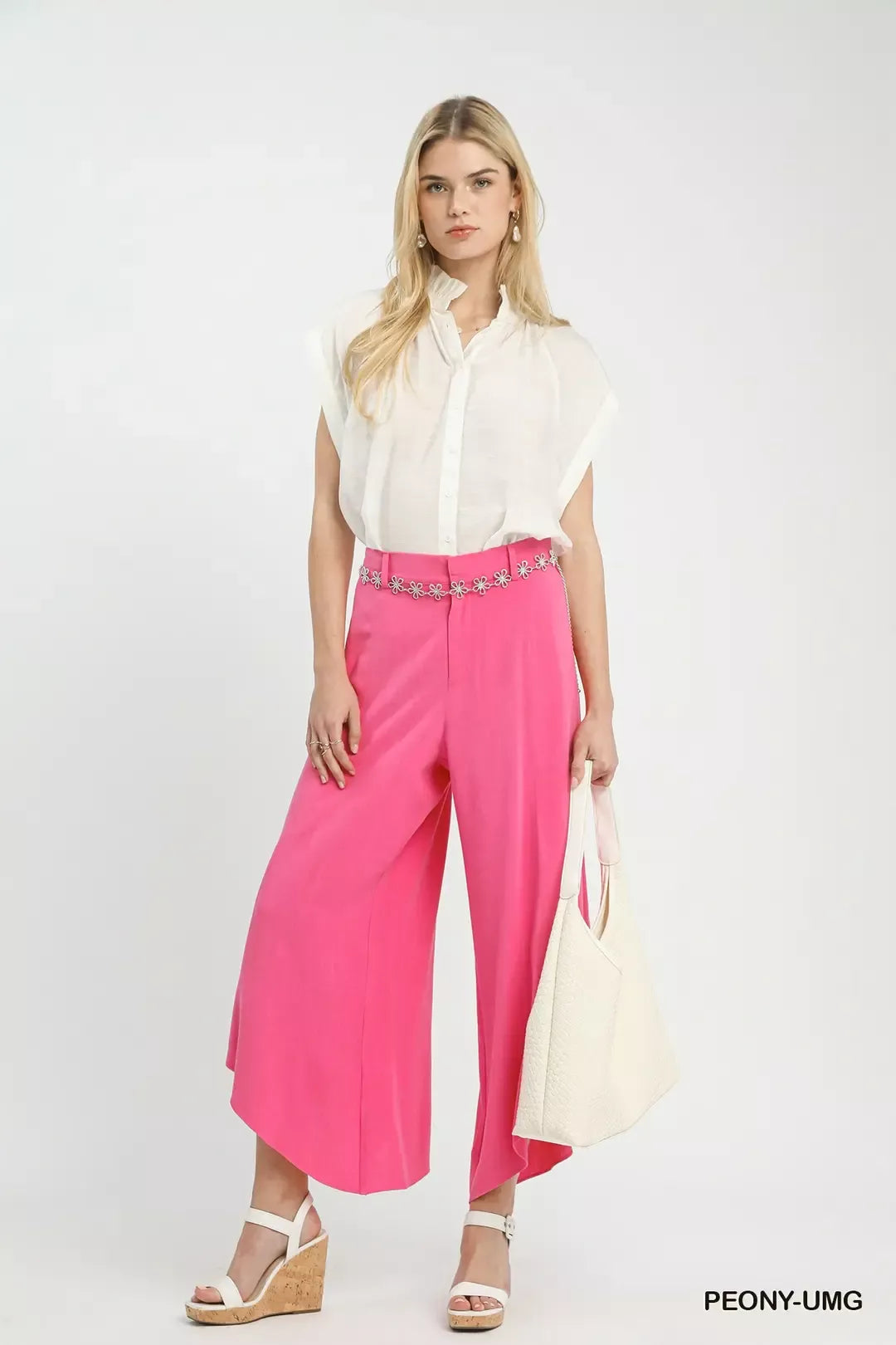 Petal Glow Asymmetrical Hem Wide-Leg Pants in bright pink with a white blouse and white wedge sandals