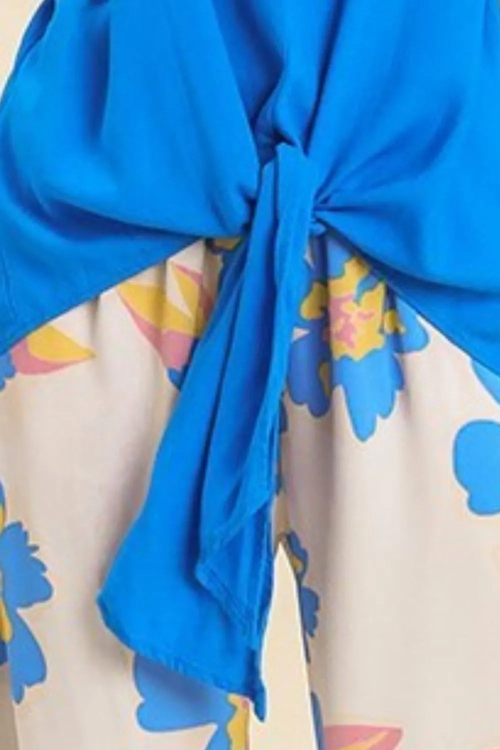 Umgee Linen Blend Frayed Detail Spaghetti Strap Cami Plus Size, blue top with a knot over a floral pattern