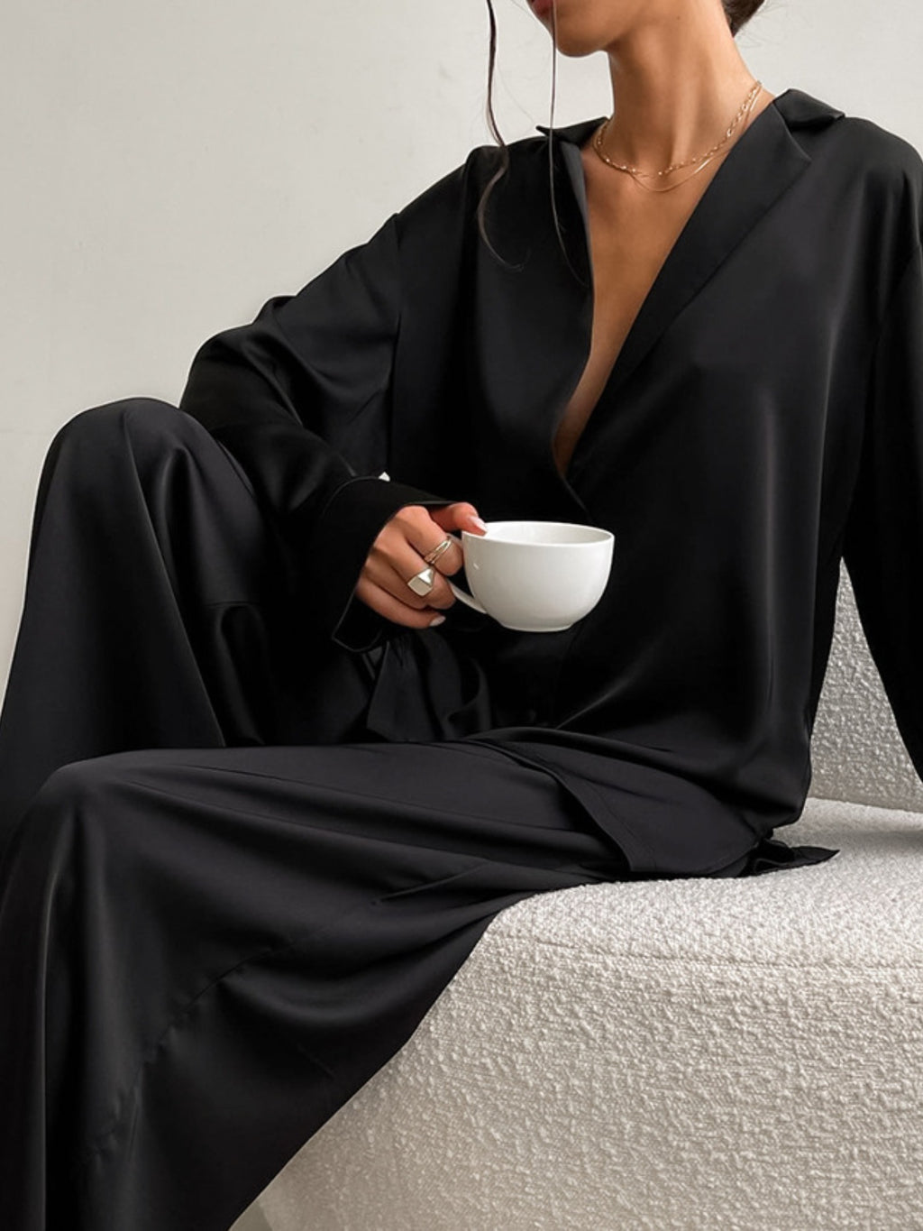 Long Sleeve Top and Wide Leg Pants Lounge Set in black, with a woman holding a white cup
