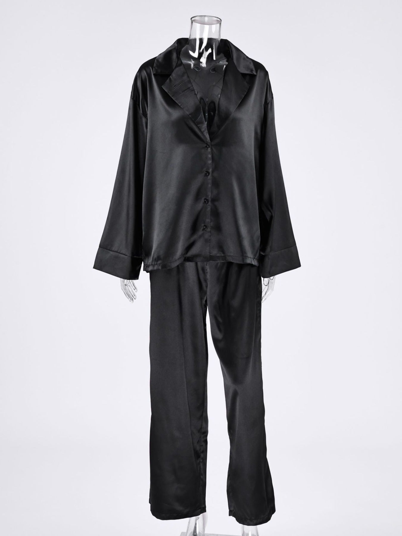 Long Sleeve Top and Wide Leg Pants Lounge Set in black satin on a mannequin