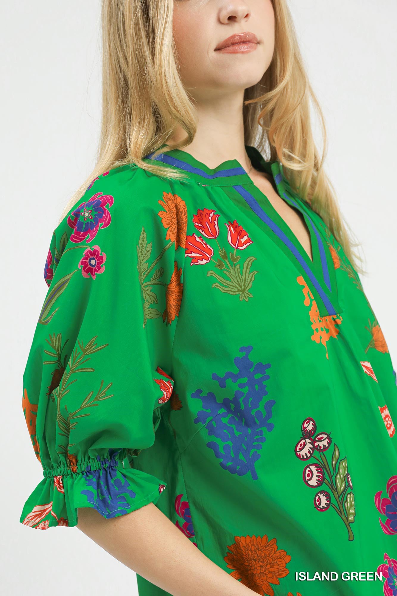 Floral Split Neck Puff Sleeve Top in Island Green with a blue trim on the neckline and cuffs