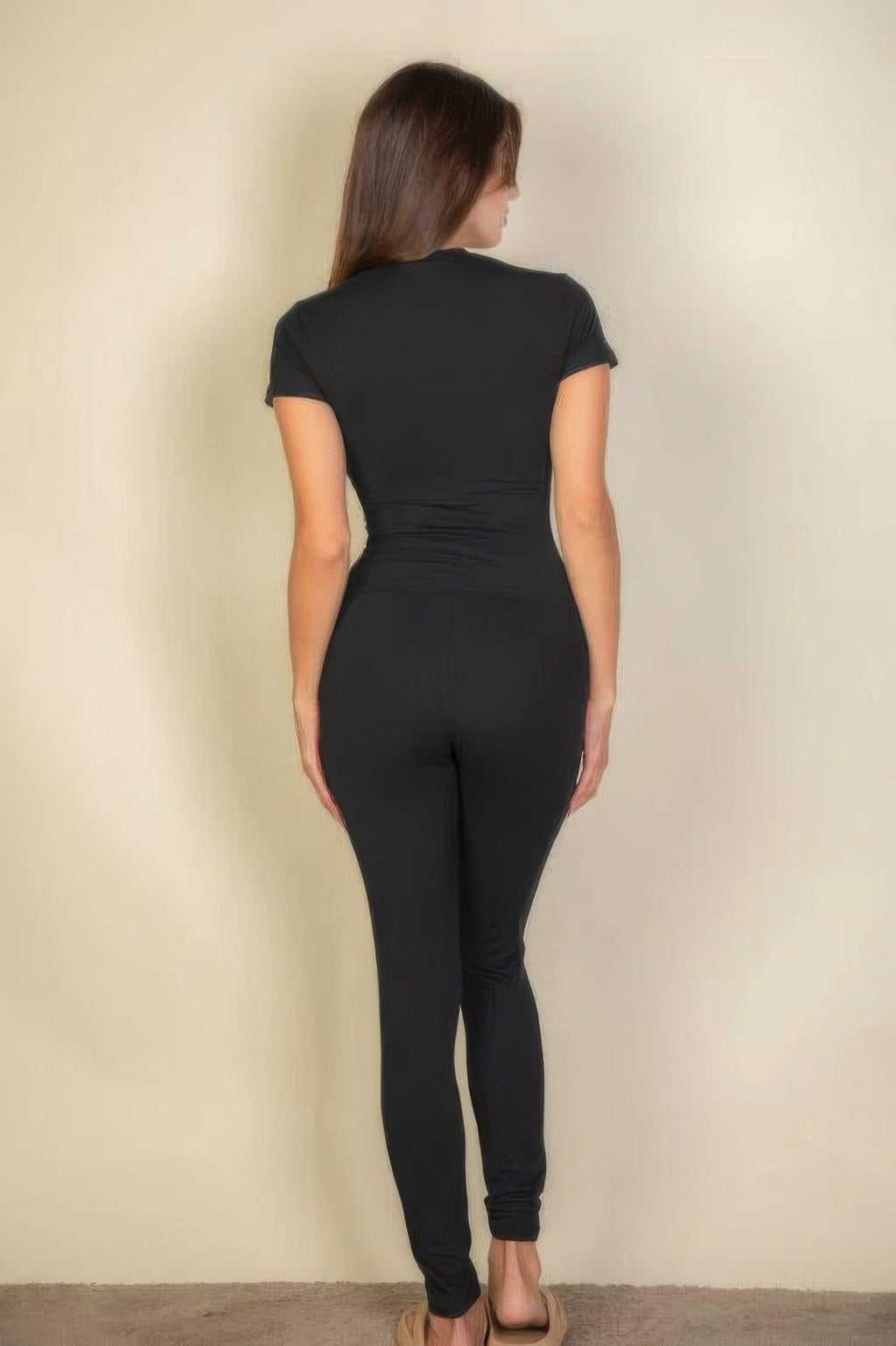 Woman from behind wearing Black Basic Solid Leggings and a black short-sleeved top