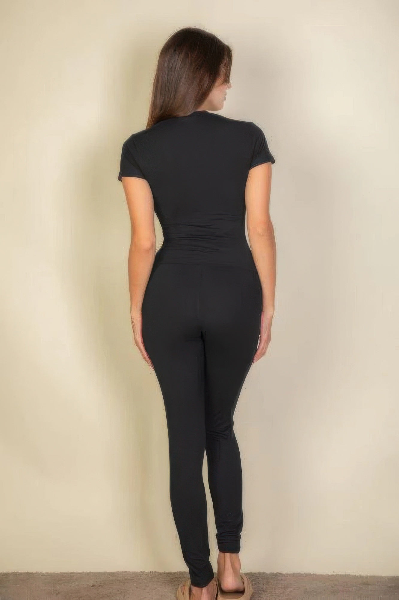 Woman from behind wearing Black Basic Solid Leggings and a black short-sleeved top