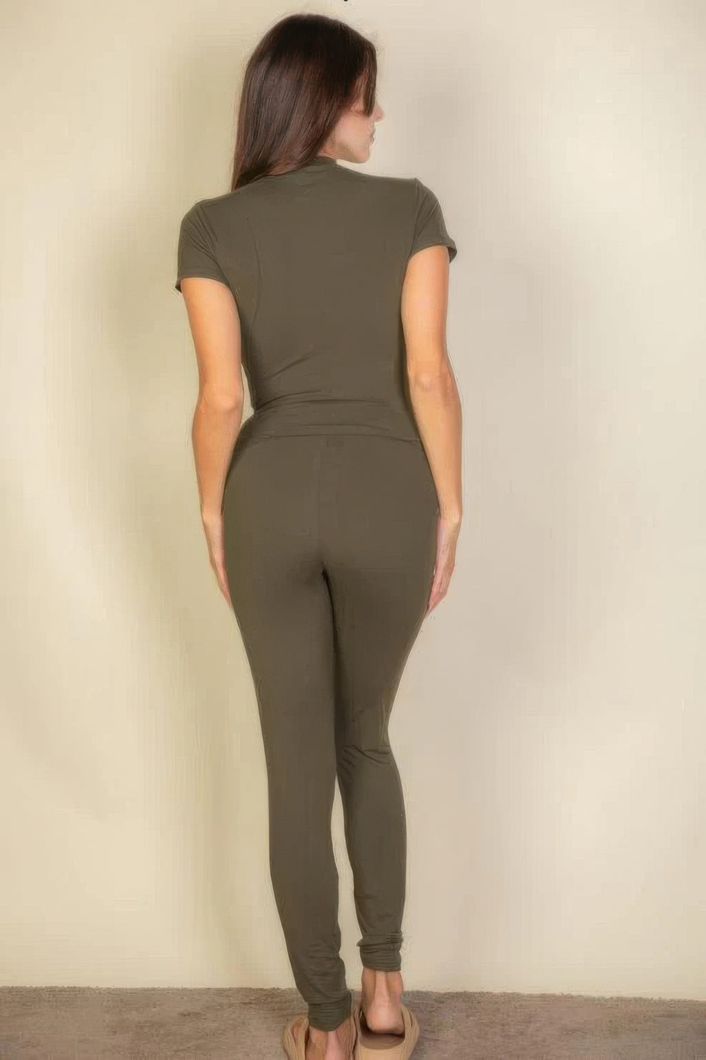 Woman facing away, wearing Olive Basic Solid Leggings and matching short-sleeved top