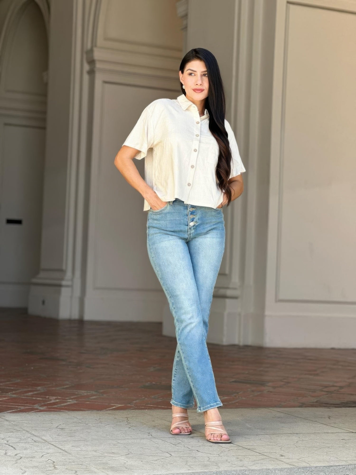 Woman wearing High Rise Cigarette Button Fly Straight Jeans and a white short-sleeved shirt