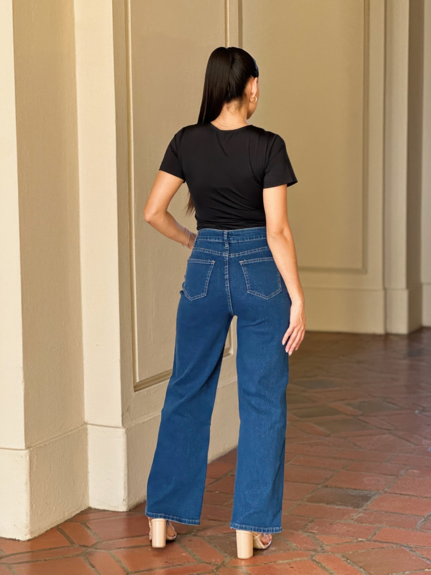 Woman from behind wearing Embroidered Wide Leg Jeans and a black top