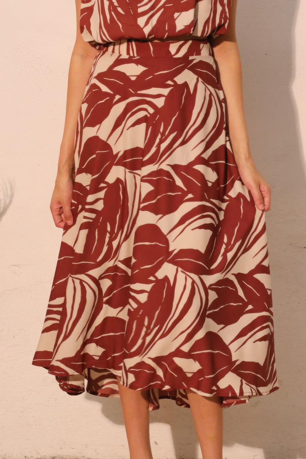 Desert Clay Botanical Midi Skirt with a red and white leaf pattern