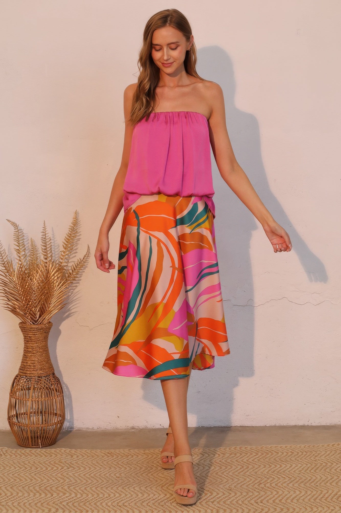 Sunset Bloom Abstract Fluid Midi Skirt with a pink strapless top and nude heels