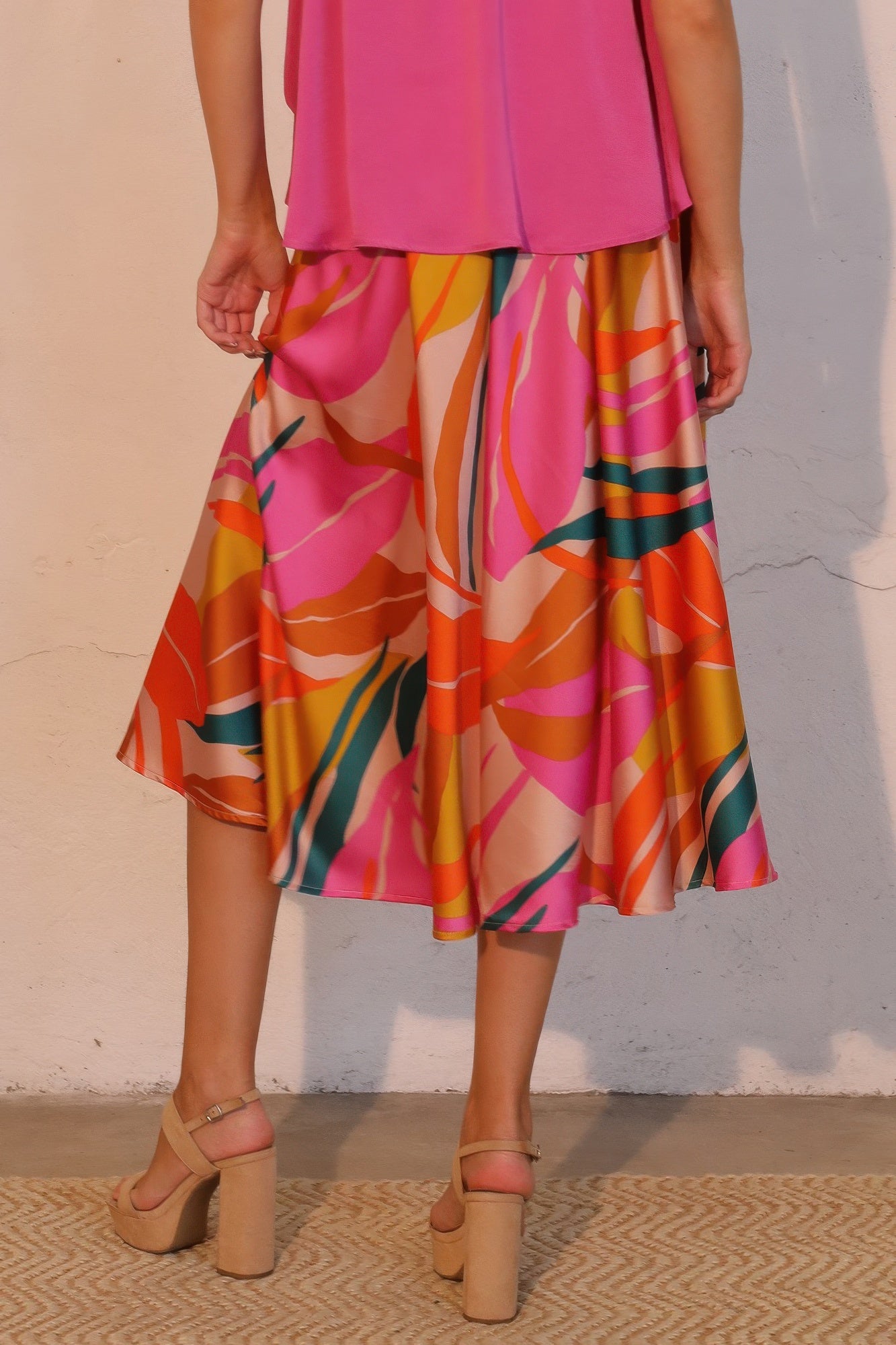 Sunset Bloom Abstract Fluid Midi Skirt with a pink top and beige platform heels