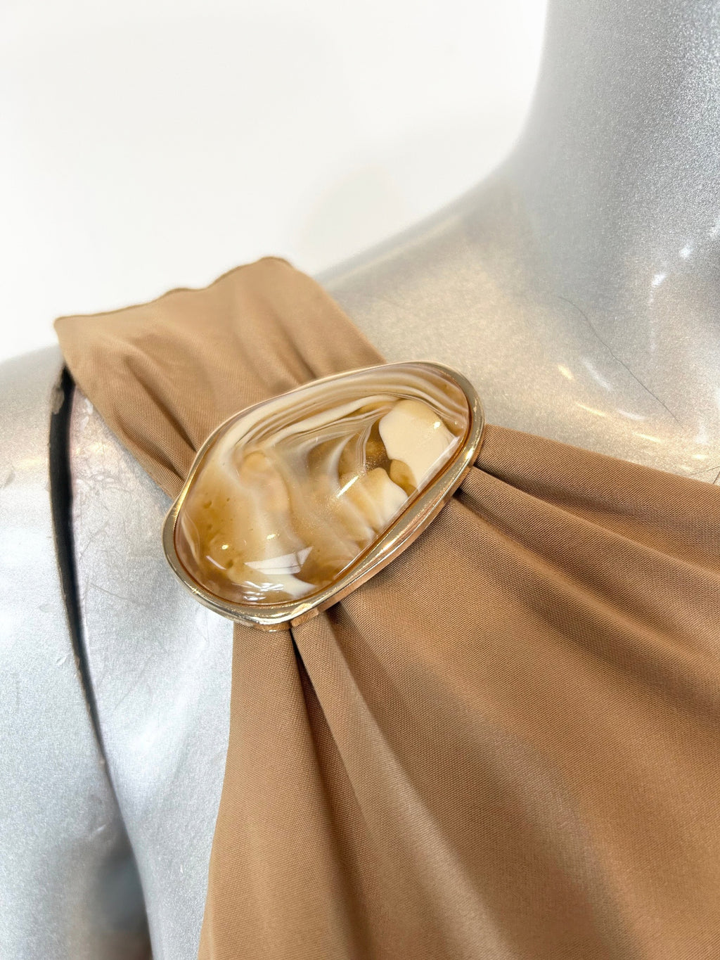 Sandstone One-Shoulder Ruched Dress with a gold and white marbled buckle detail