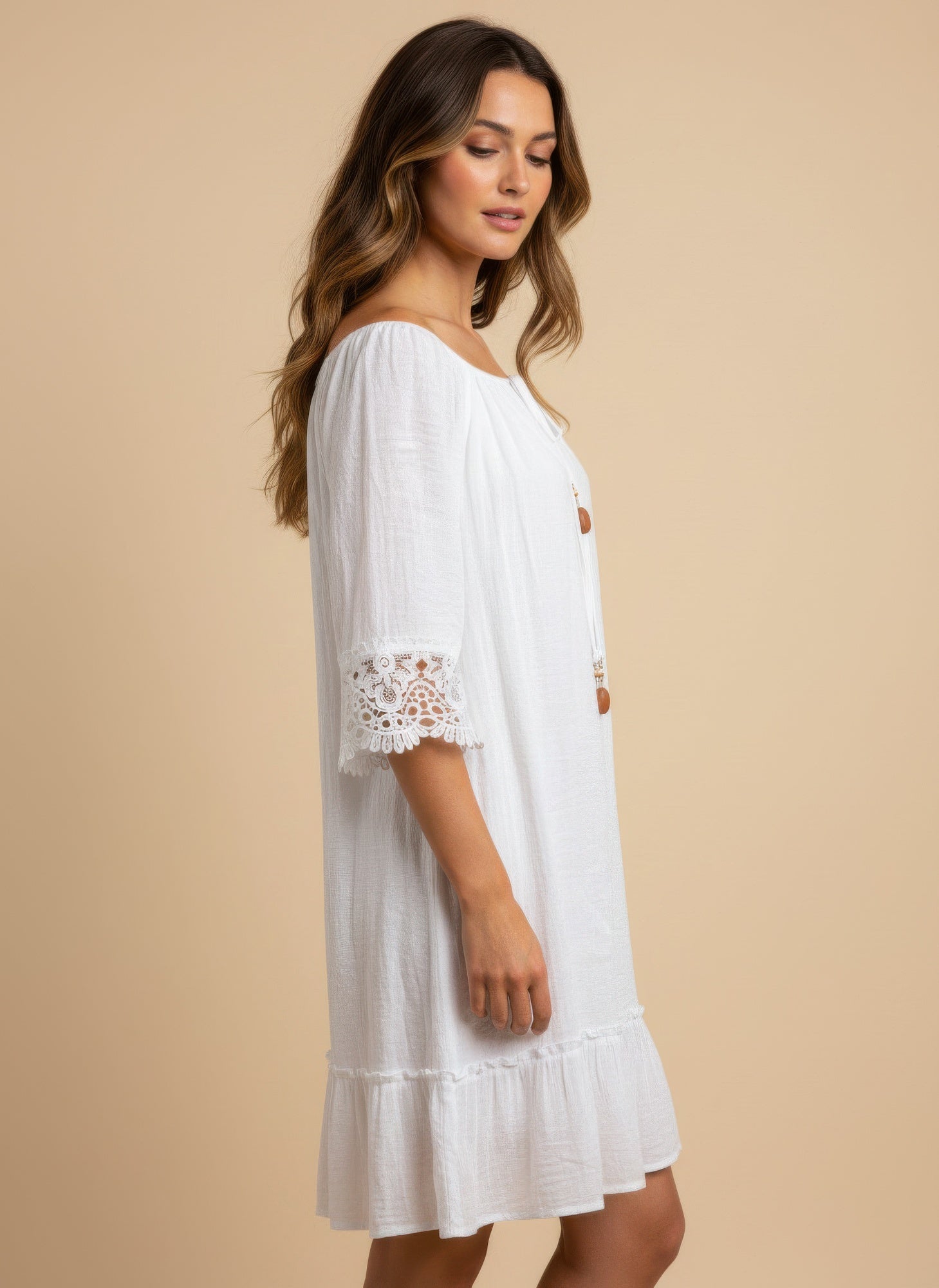White Off-Shoulder Lace-Cuff Dress with long brown hair, looking down