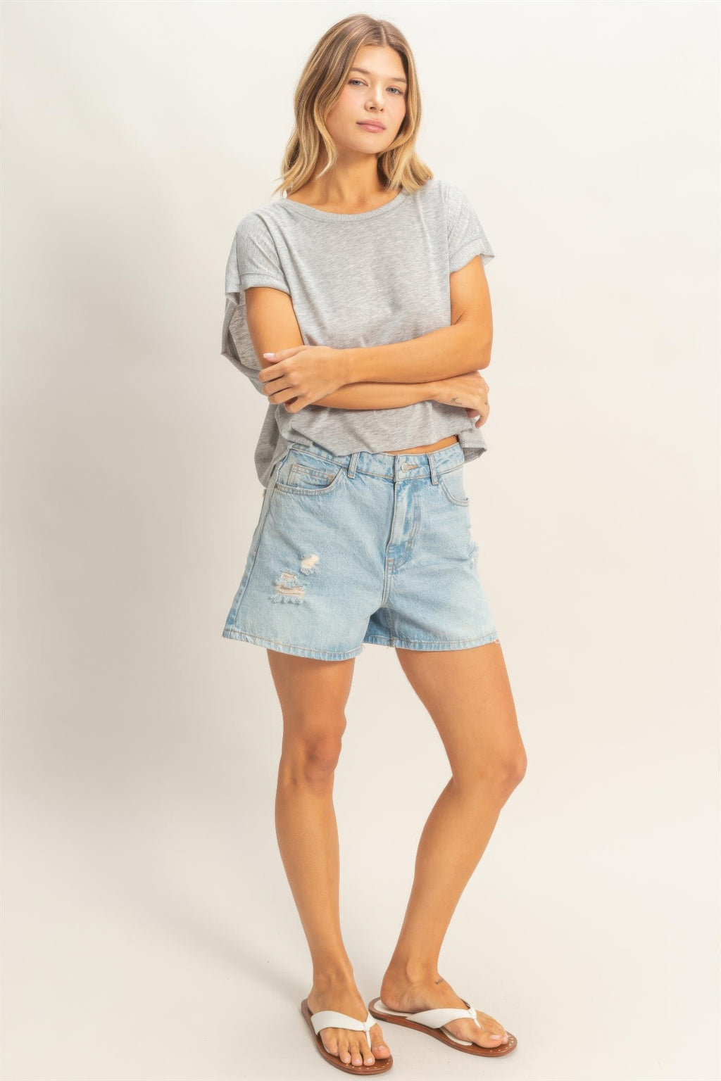 Woman wearing Silver Cloud Boxy Cropped Tee and denim shorts