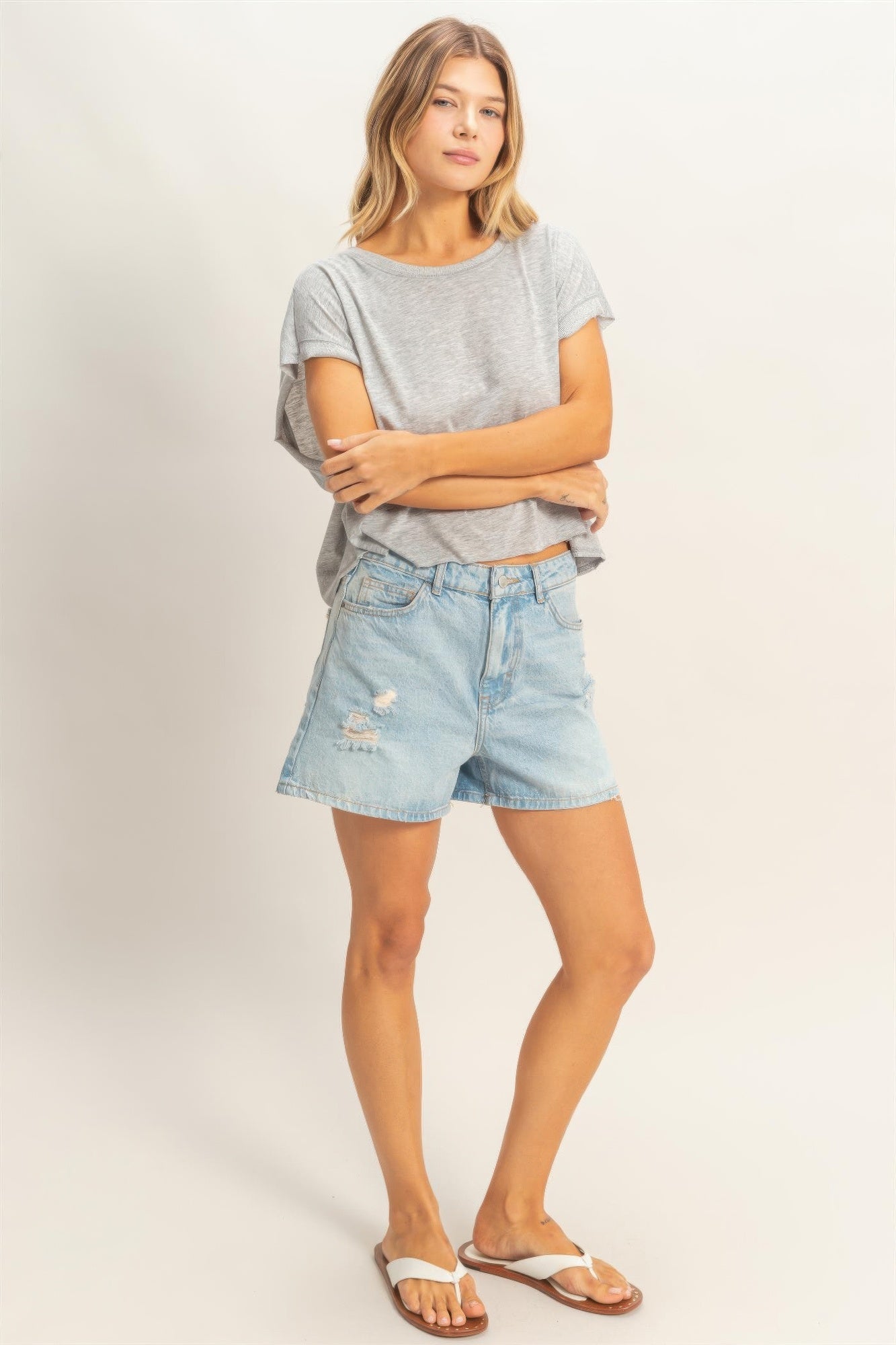 Woman wearing Silver Cloud Boxy Cropped Tee and denim shorts