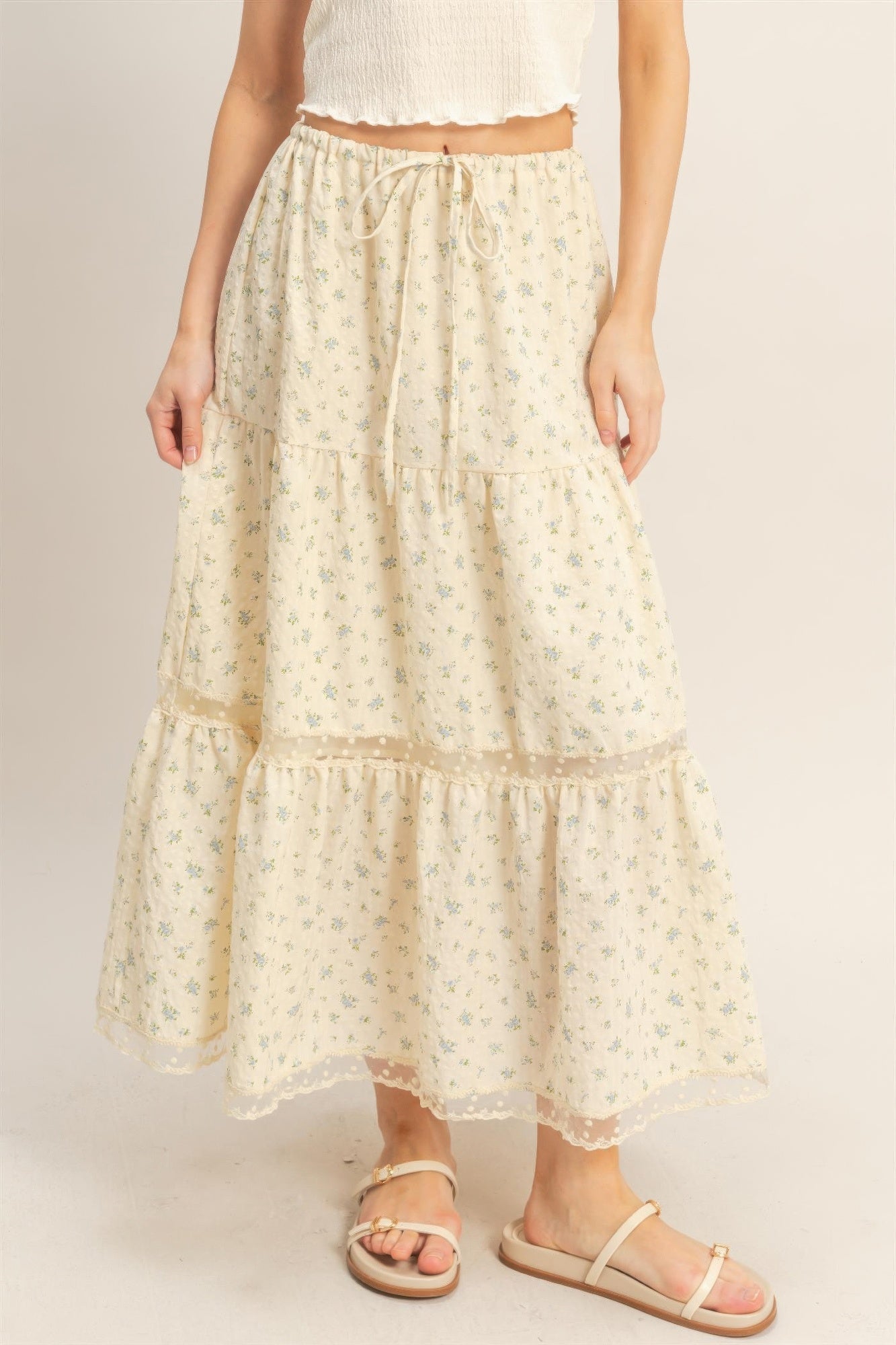 Vanilla Bluebell Tiered Midi Skirt with blue floral print and white sandals
