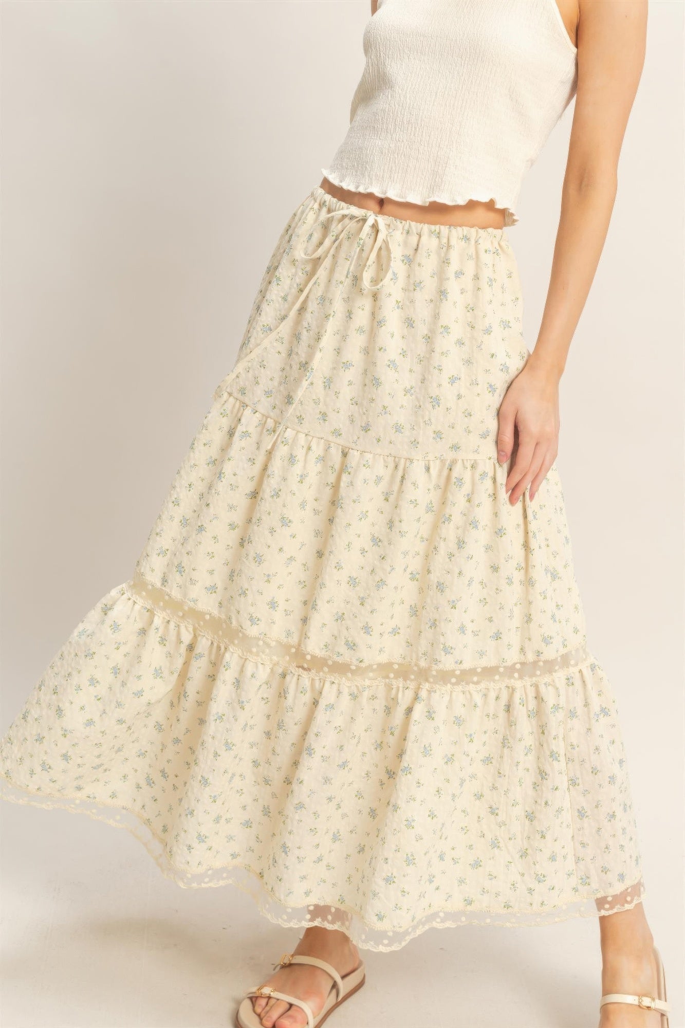 Vanilla Bluebell Tiered Midi Skirt with small blue floral print, white crop top, and sandals