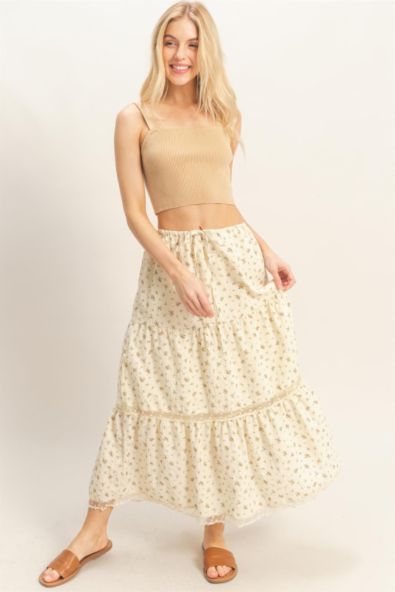 Blonde woman in a Buttercream Blossom Tiered Midi Skirt and a beige crop top