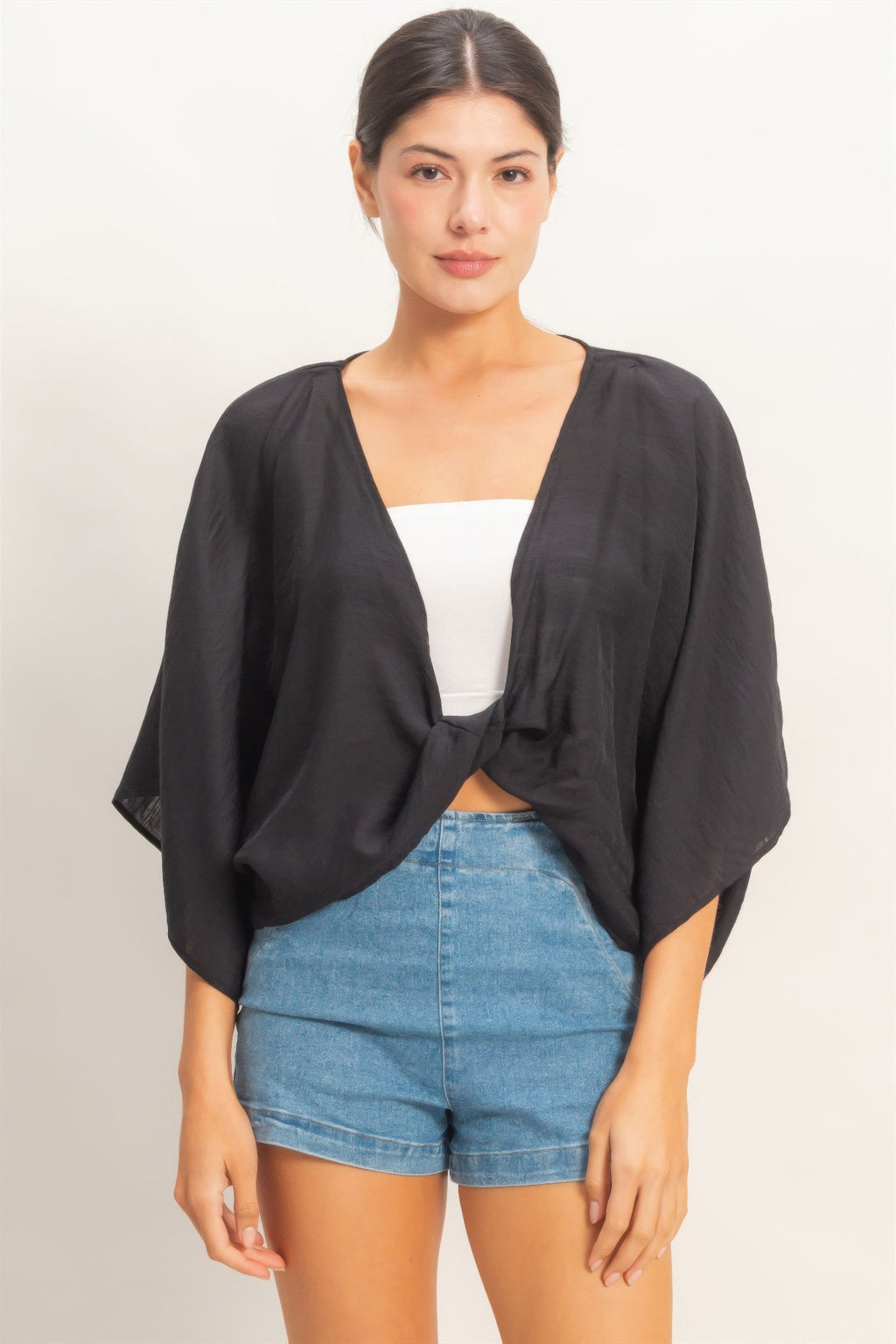 Ink Black Twist-Front Draped Shrug Top over a white bandeau and denim shorts