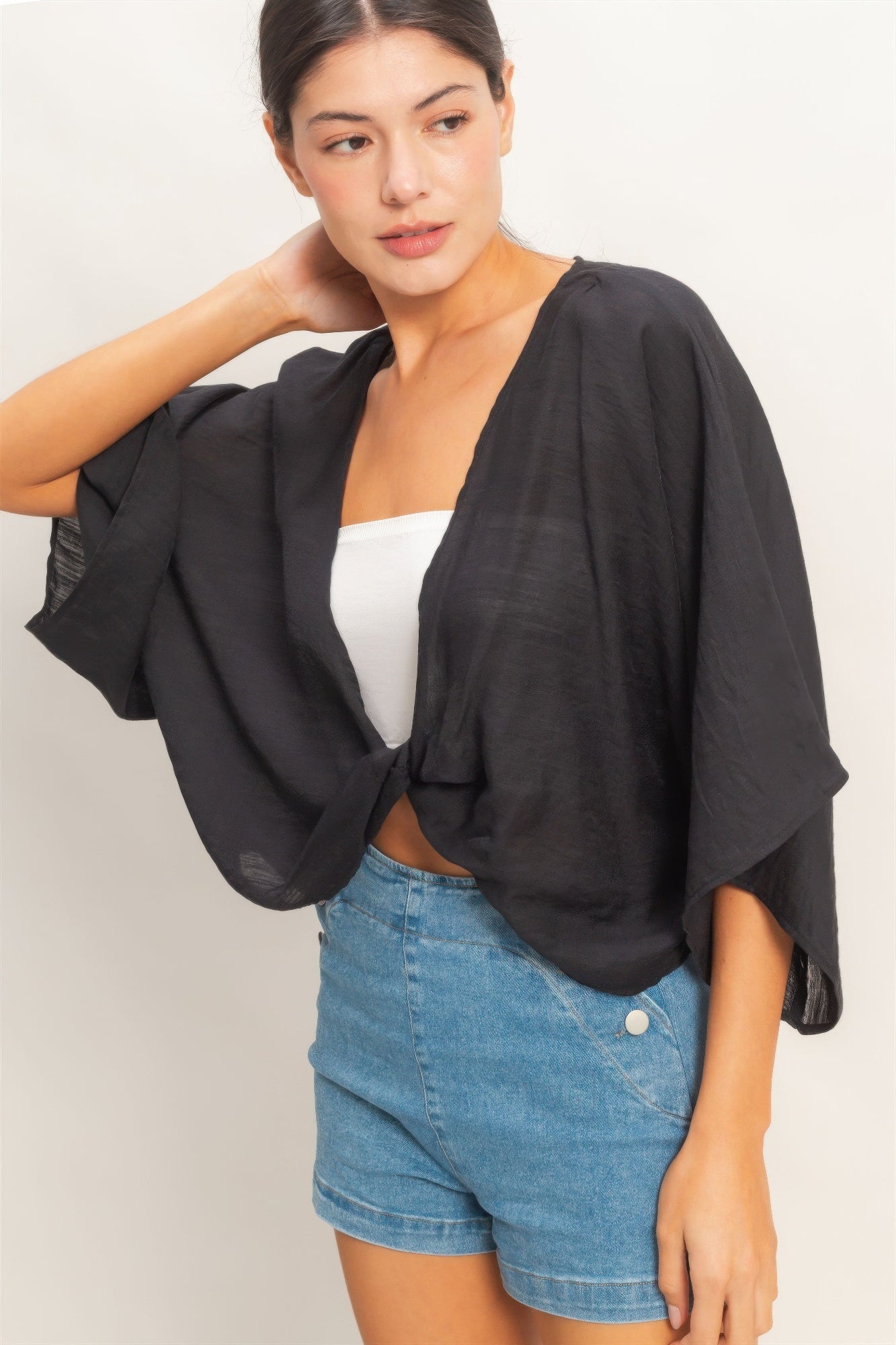 Ink Black Twist-Front Draped Shrug Top with white bandeau and denim shorts