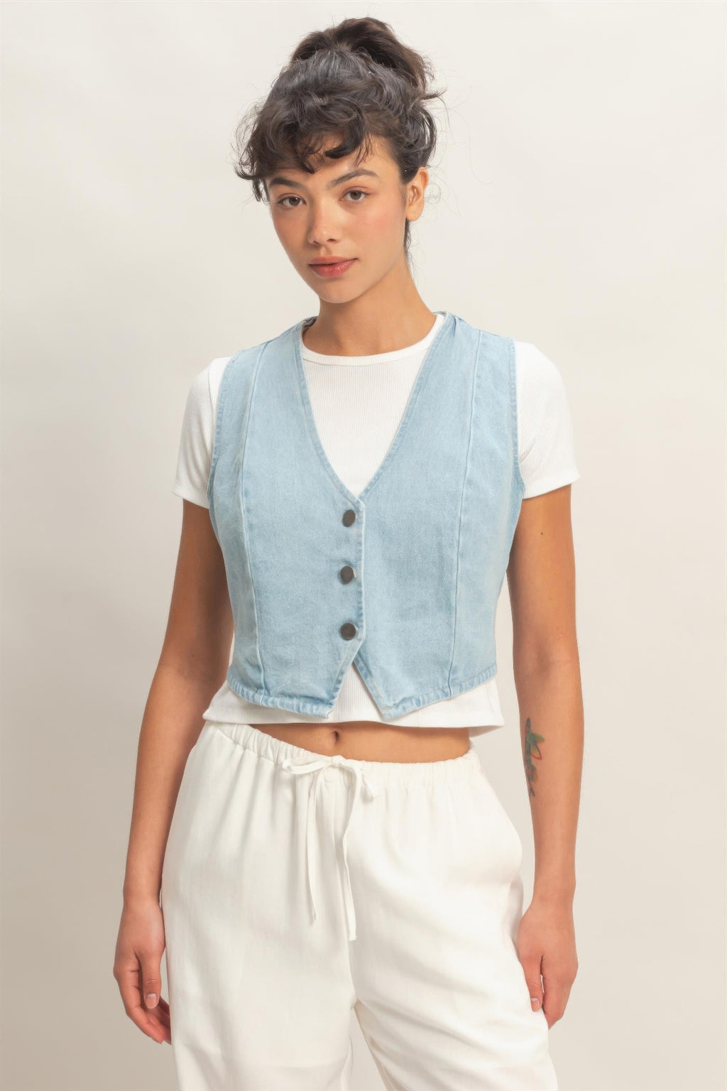 Washed Sky Denim Button-Front Cropped Vest over a white t-shirt and white pants