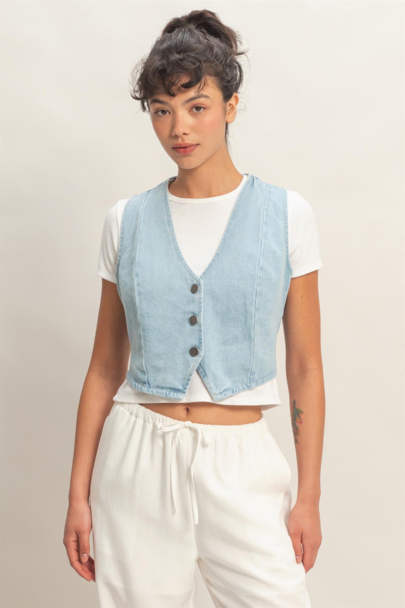 Washed Sky Denim Button-Front Cropped Vest over a white t-shirt and white pants