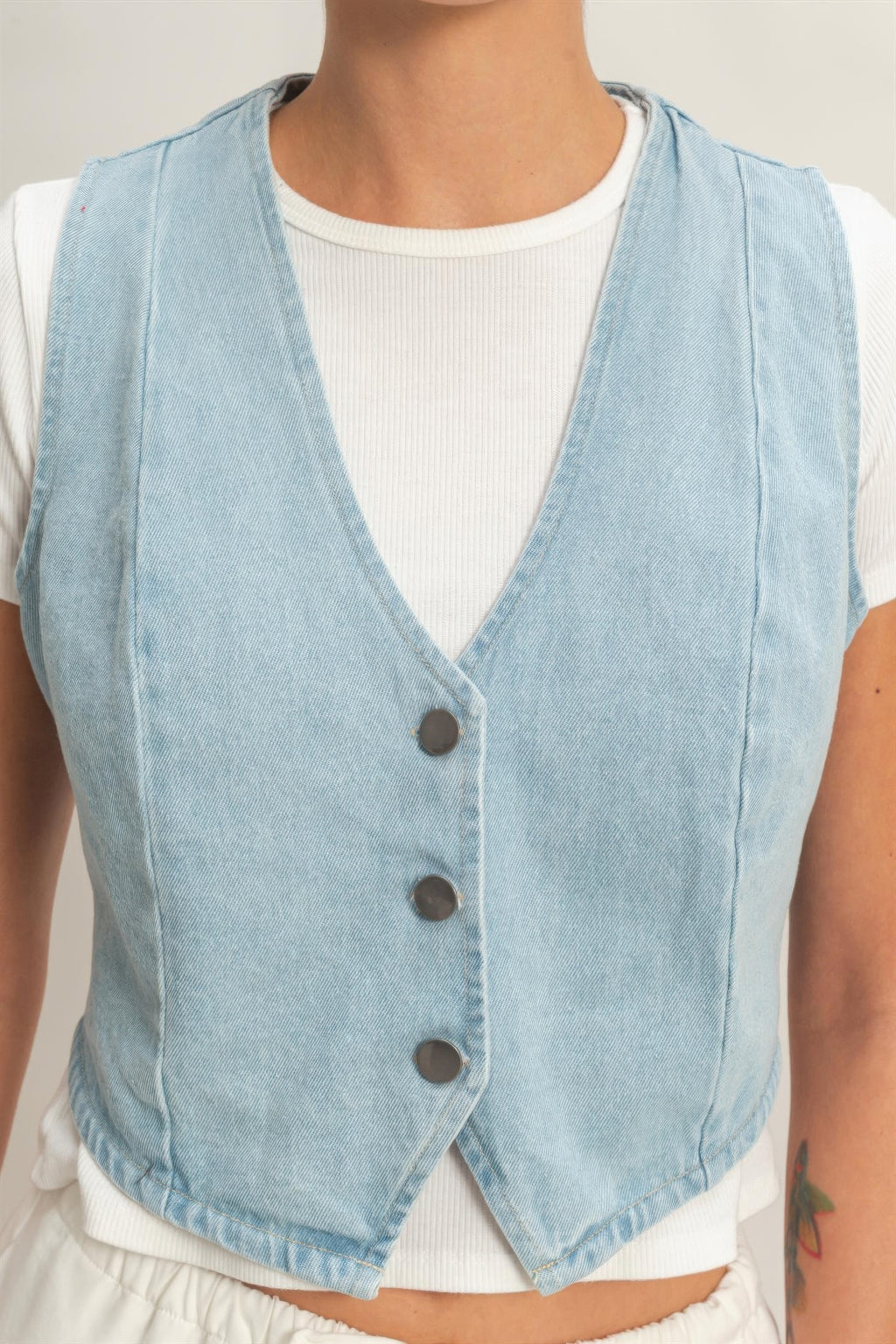 Washed Sky Denim Button-Front Cropped Vest over a white ribbed top