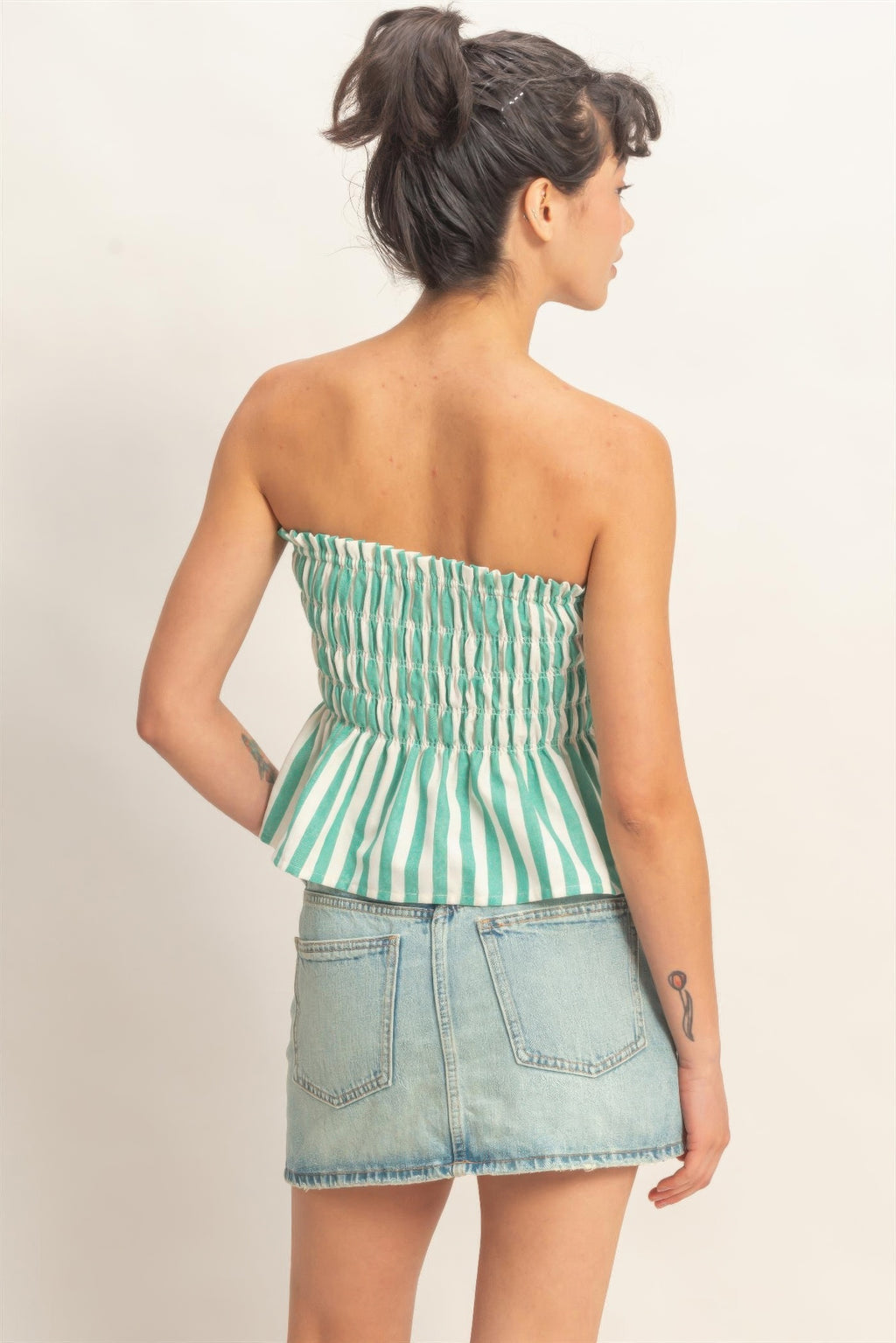 Seafoam Stripe Smocked Peplum Strapless Top with light wash denim skirt, back view