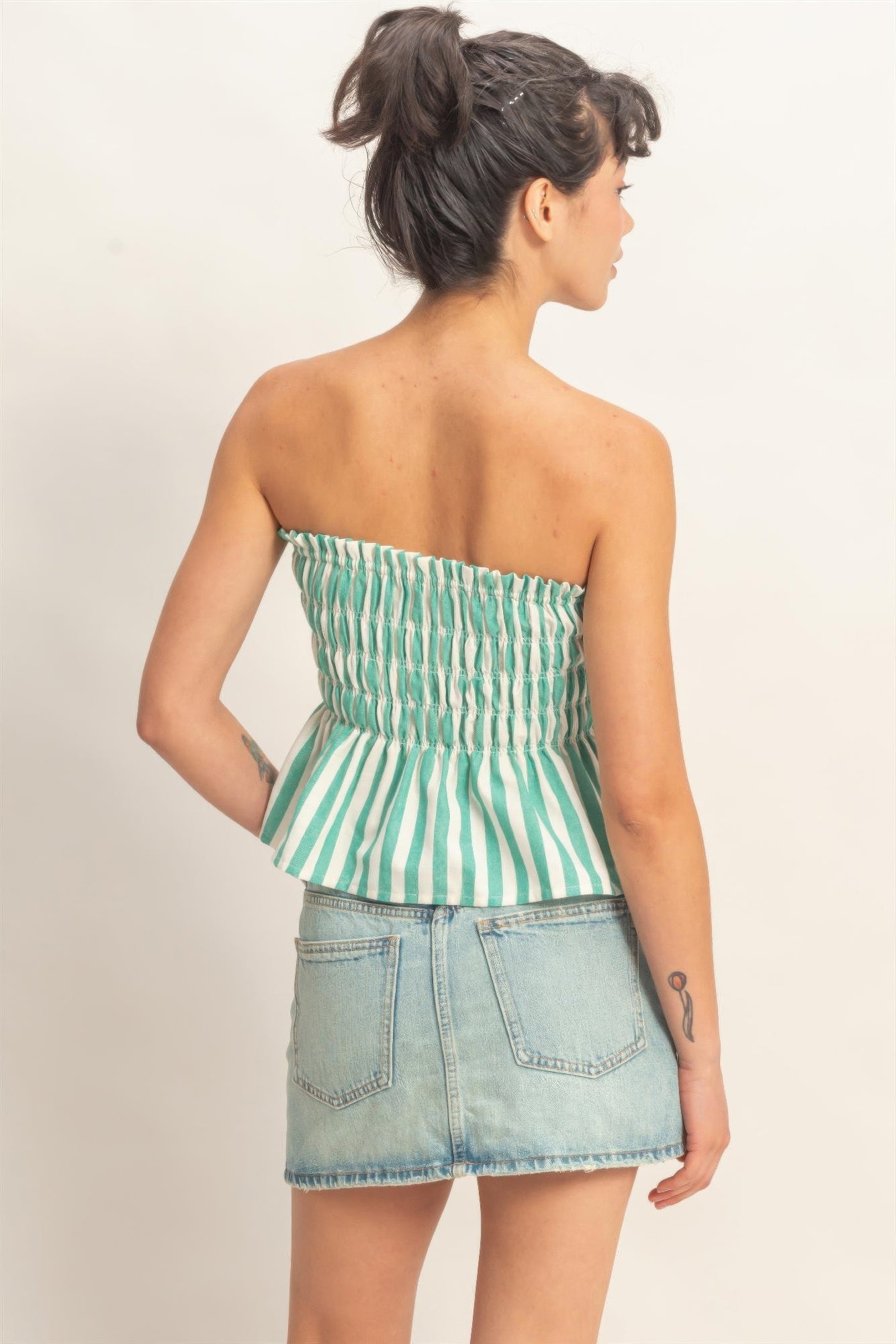 Seafoam Stripe Smocked Peplum Strapless Top with light wash denim skirt, back view