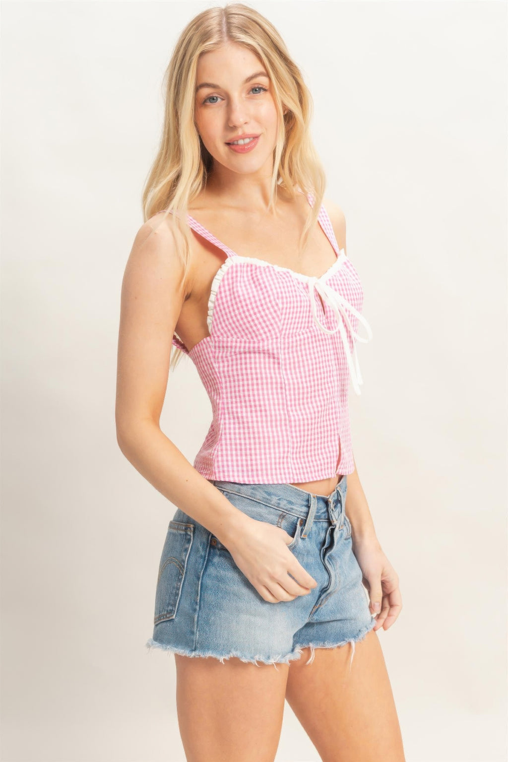 Petal Gingham Lace-Up Smocked Tank Top with white lace trim and bow, paired with denim shorts