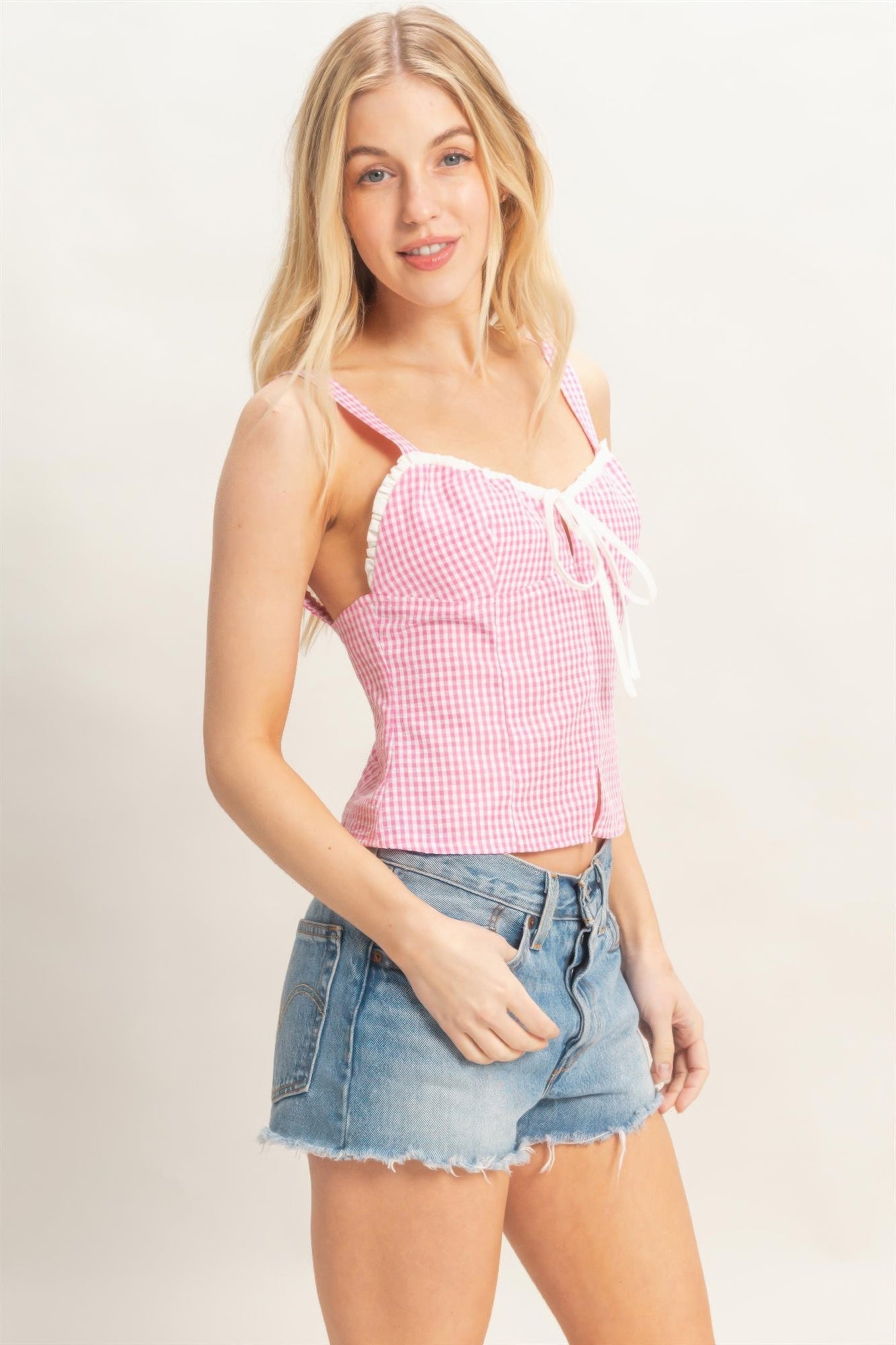 Petal Gingham Lace-Up Smocked Tank Top with white lace trim and bow, paired with denim shorts