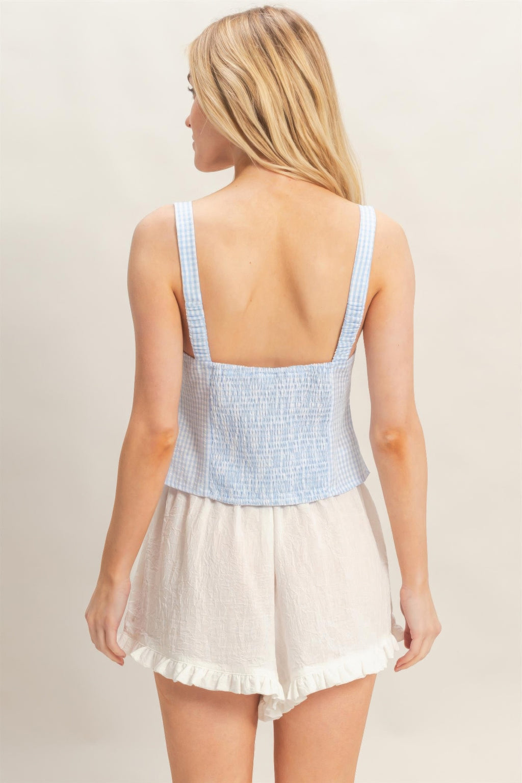 Back view of Porcelain Sky Blue Gingham Lace-Up Smocked Tank Top with white shorts