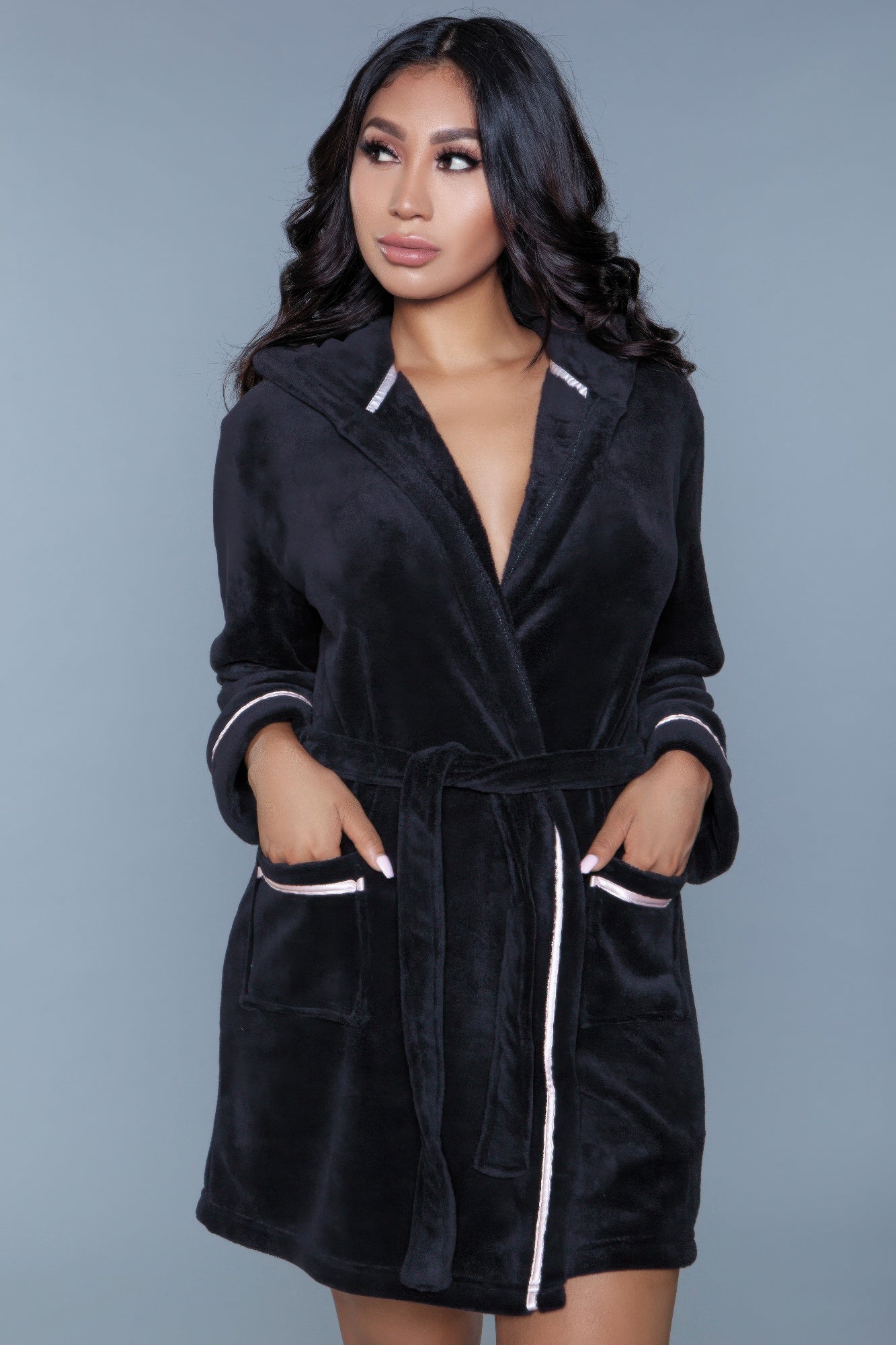 Alyssa Robe in black with pink trim, tied at the waist, hands in pockets