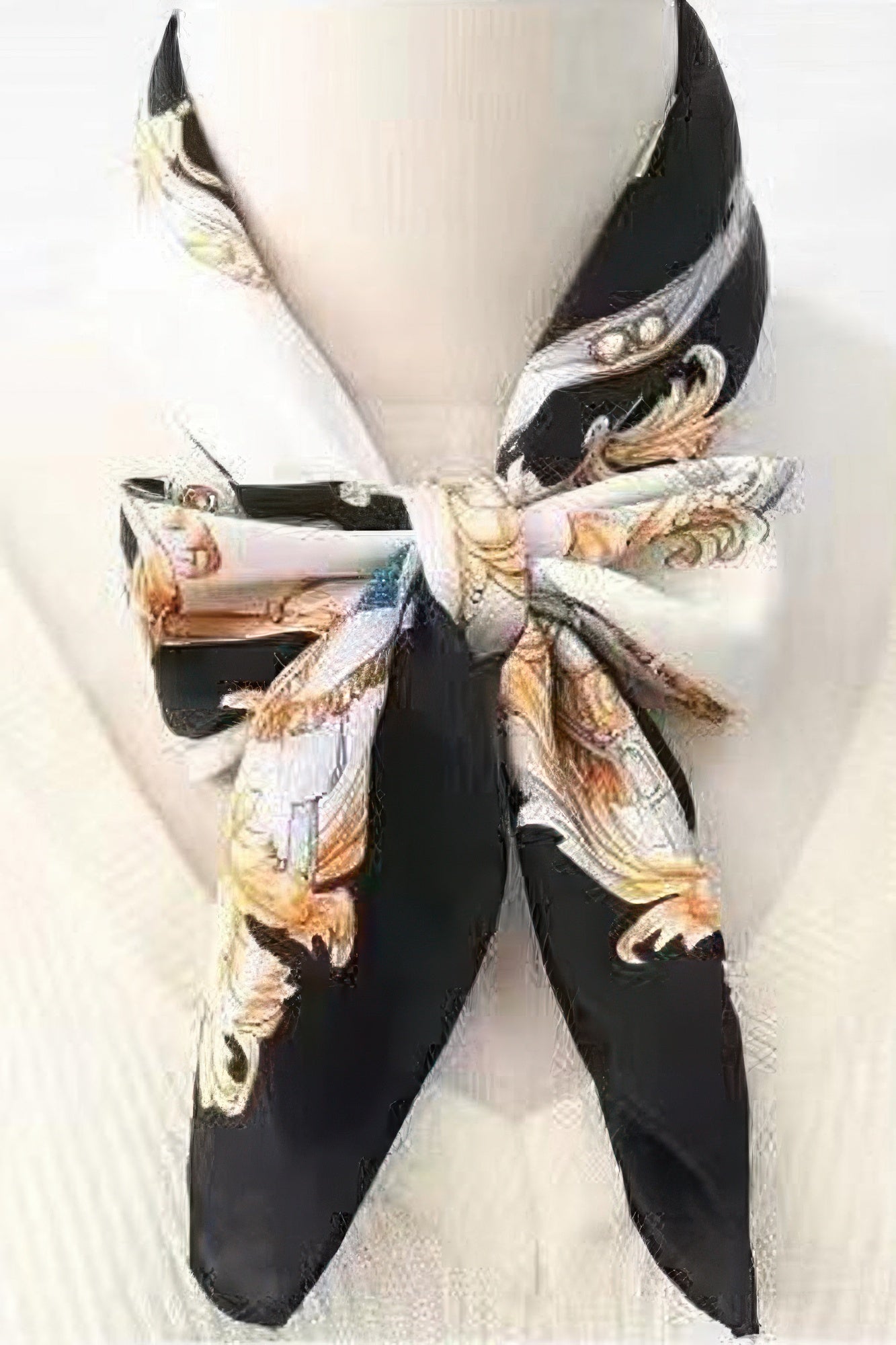Multi Print Bandana tied around a neck, featuring black, white, and gold ornate patterns
