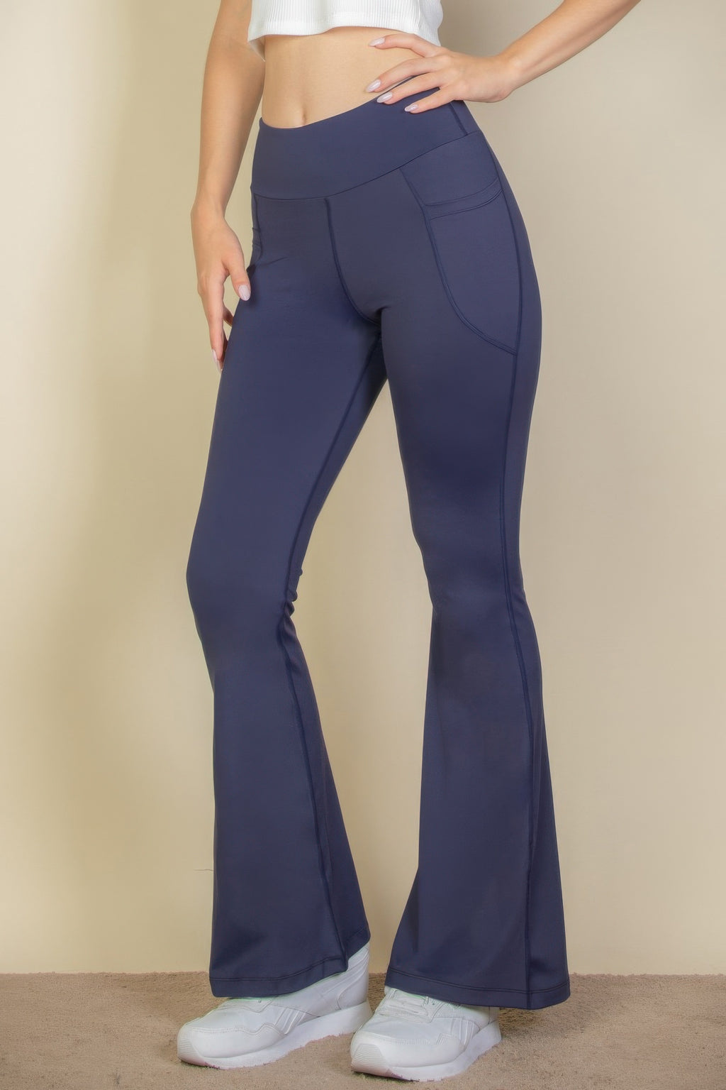 High-Waist Flare Leggings with Side Pockets in navy blue worn by a person