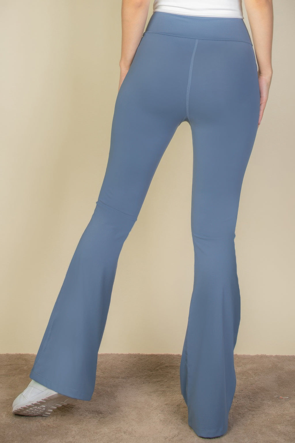 Back view of High-Waist Flare Leggings with Side Pockets in blue, worn by a person