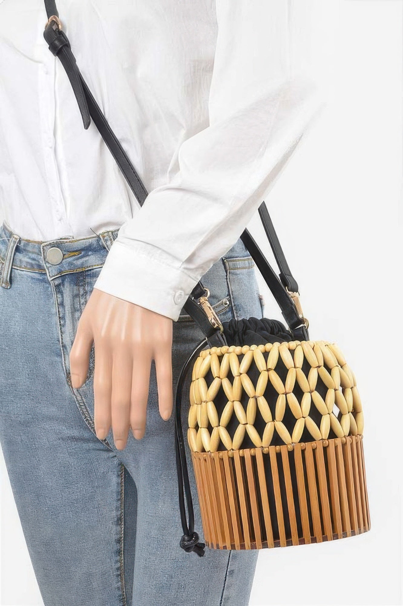 Handmade Bamboo Clutch with black drawstring lining, worn over the shoulder with a white shirt and blue jeans