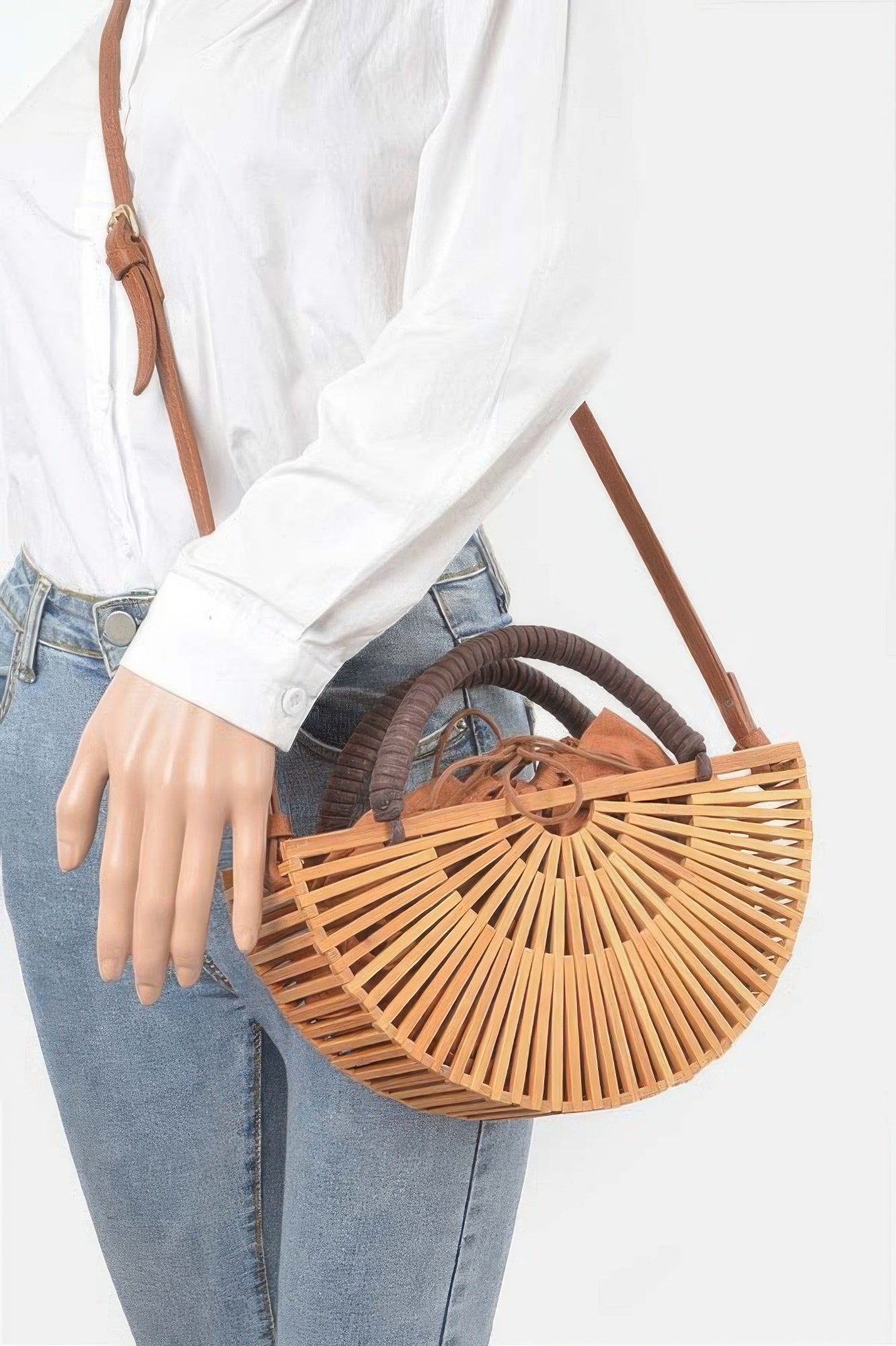 Handmade Bamboo Clutch with brown leather strap and handles, worn over the shoulder with jeans and a white shirt