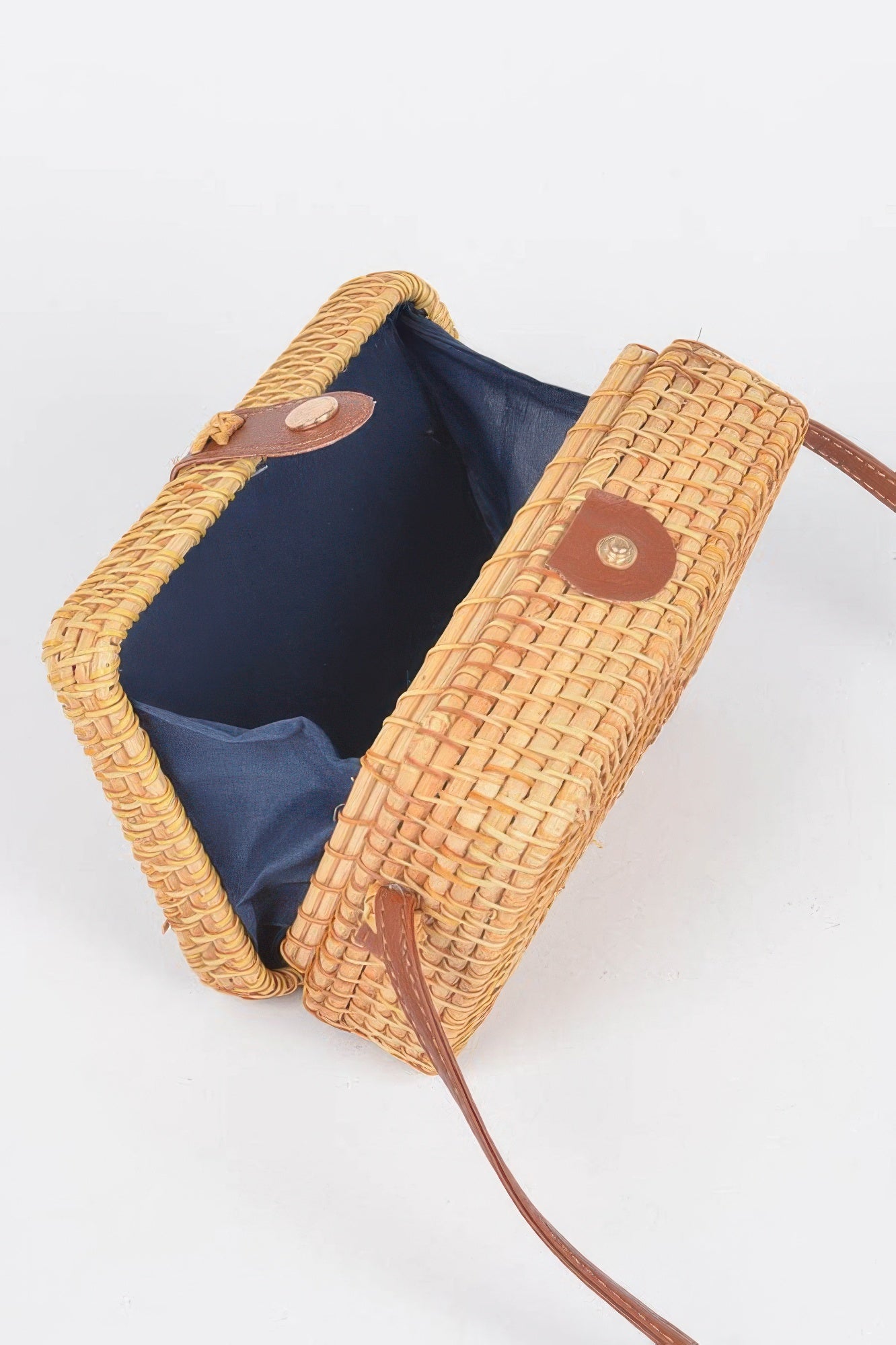 Crossbody Bamboo Box Bag, open, showing blue fabric lining and brown leather strap and closures